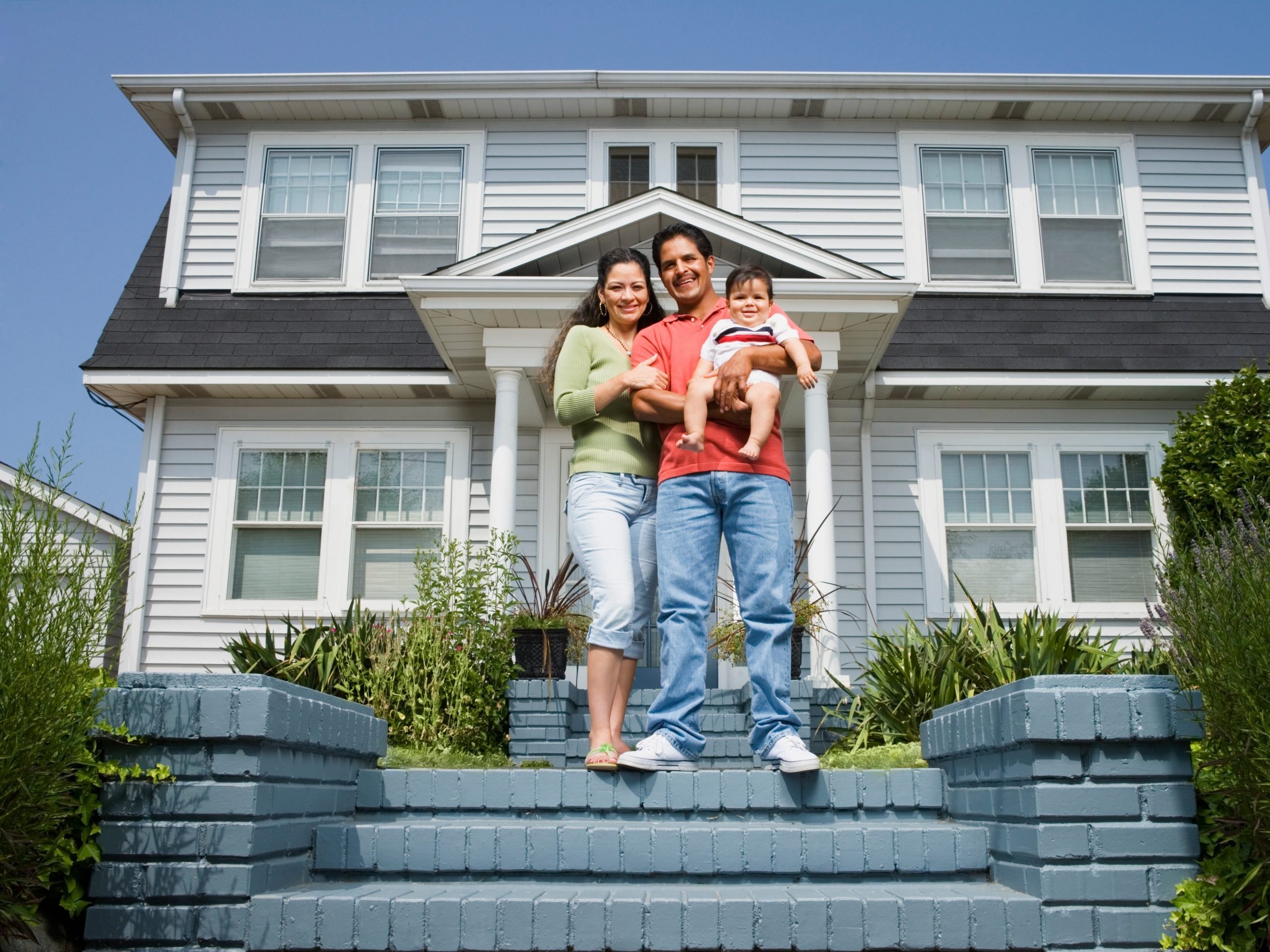 Family standing outside a home.