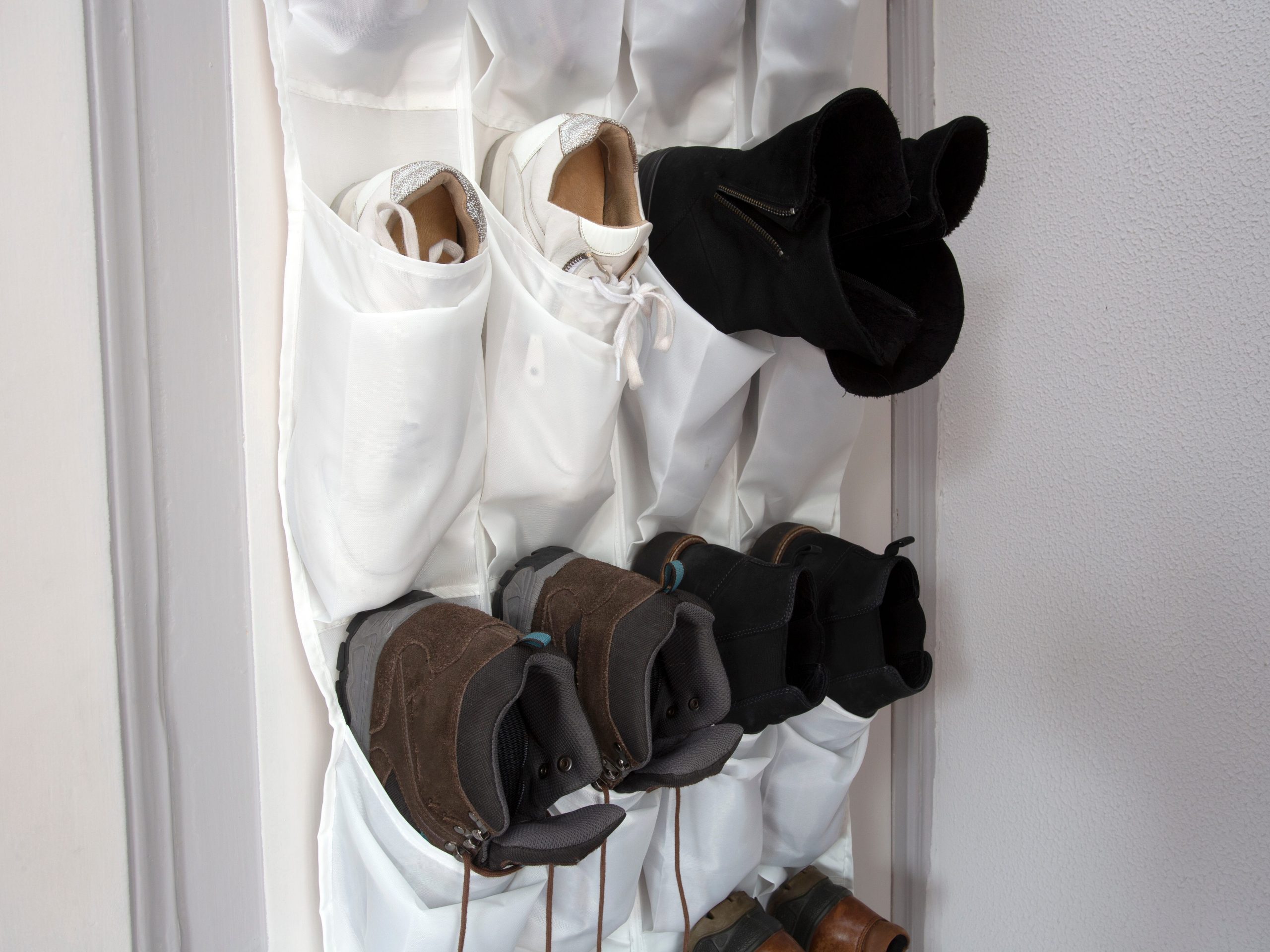 White shoe hanger with shoes in it on door