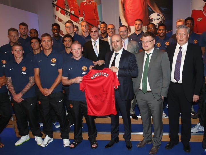 he Manchester United squad pose with CEO of Aeroflot Vitaly Saveliev and representatives from Aeroflot after the press conference to announce Aeroflot as new Manchester United club partners at Old Trafford on July 8, 2013 in Manchester, England