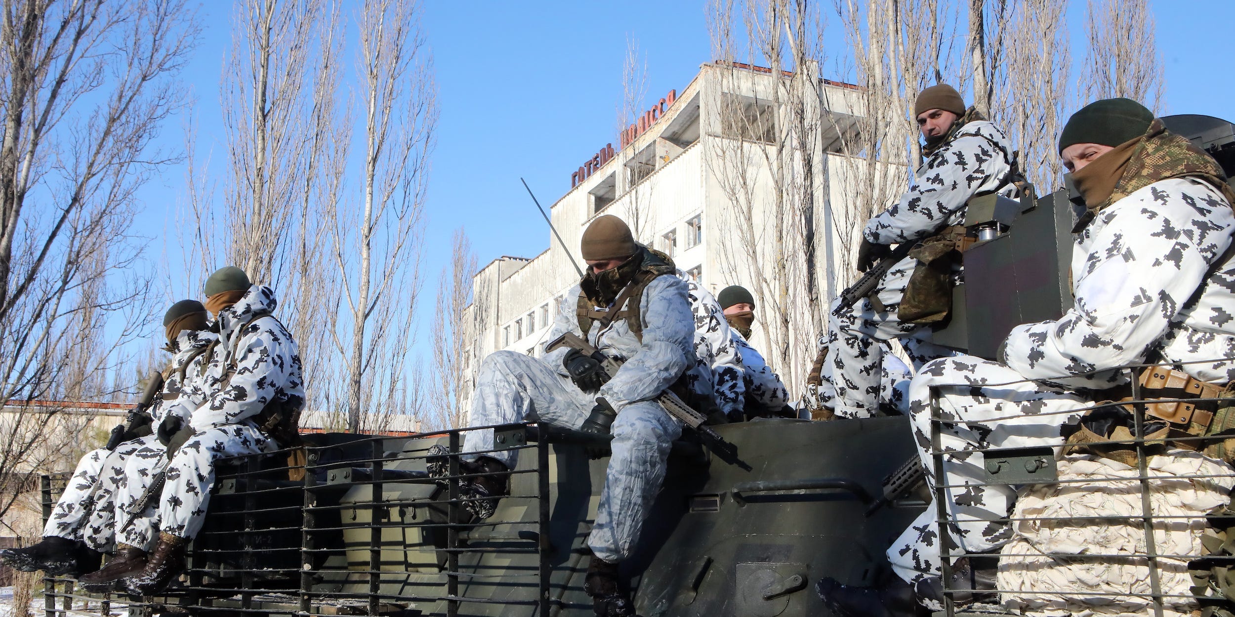 Soldiers sit inside the Chernobyl Exclusion Zone