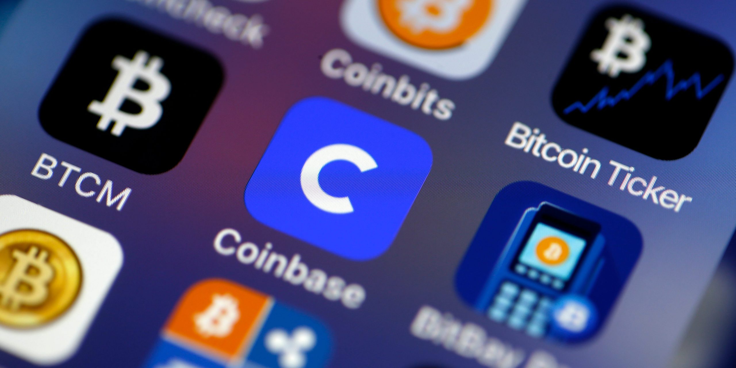 Coinbase cryptocurrency exchange logo is seen on the screen of an iPhone on February 26, 2021 in Paris, France.