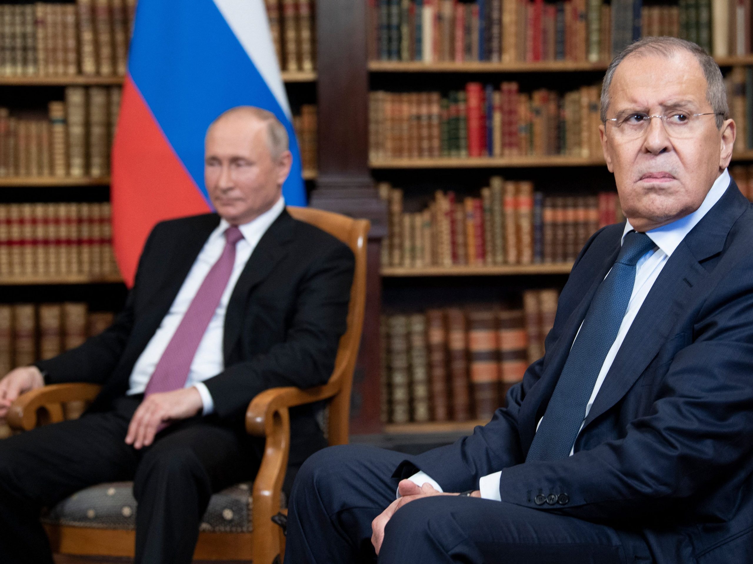 Russian Foreign Minister Sergei Lavrov looks on, next to Russian President Vladimir Putin, as they wait for the US-Russia summit at the Villa La Grange, in Geneva on June 16, 2021.