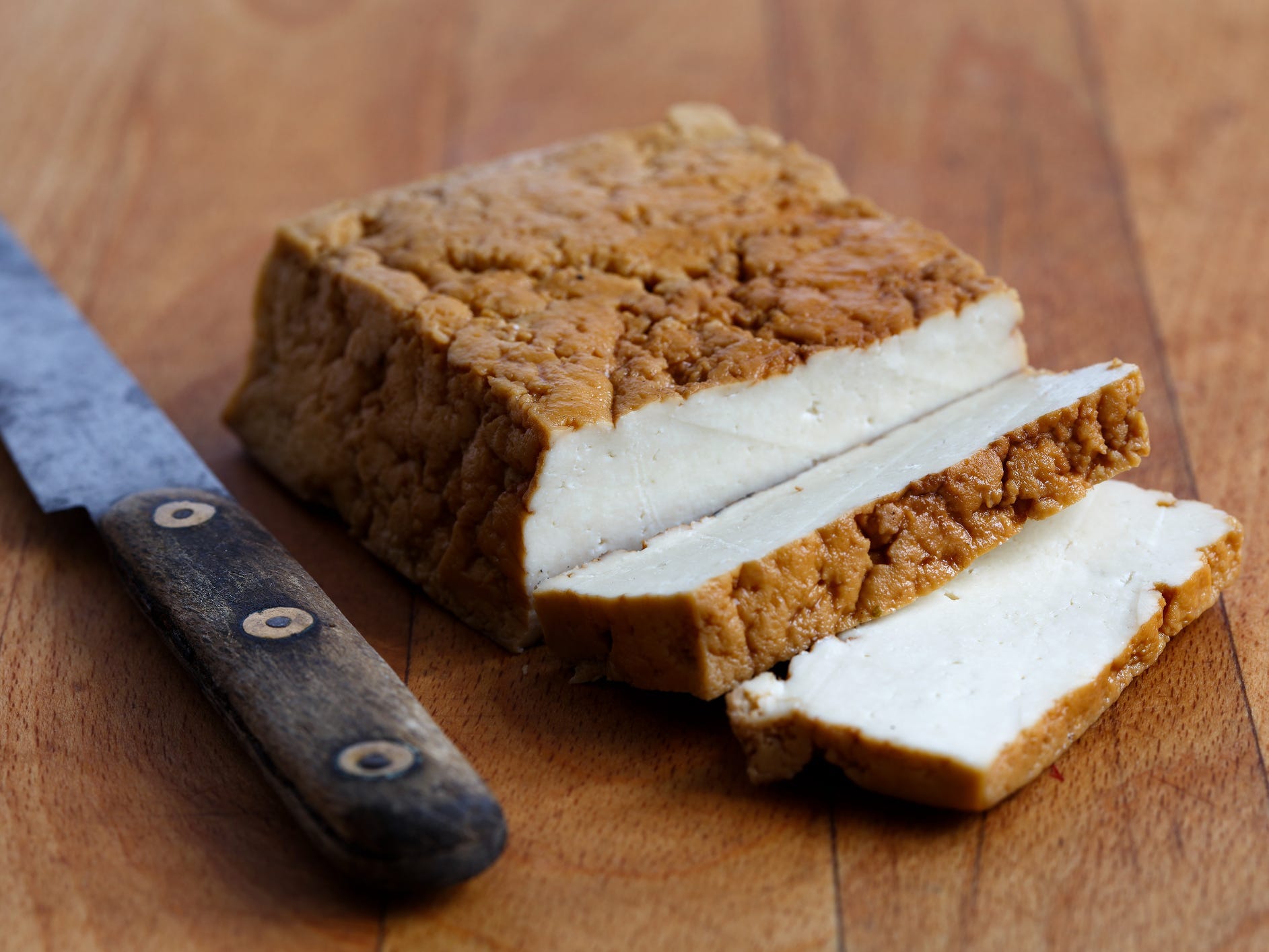 Smoked tofu on wooden cutting board