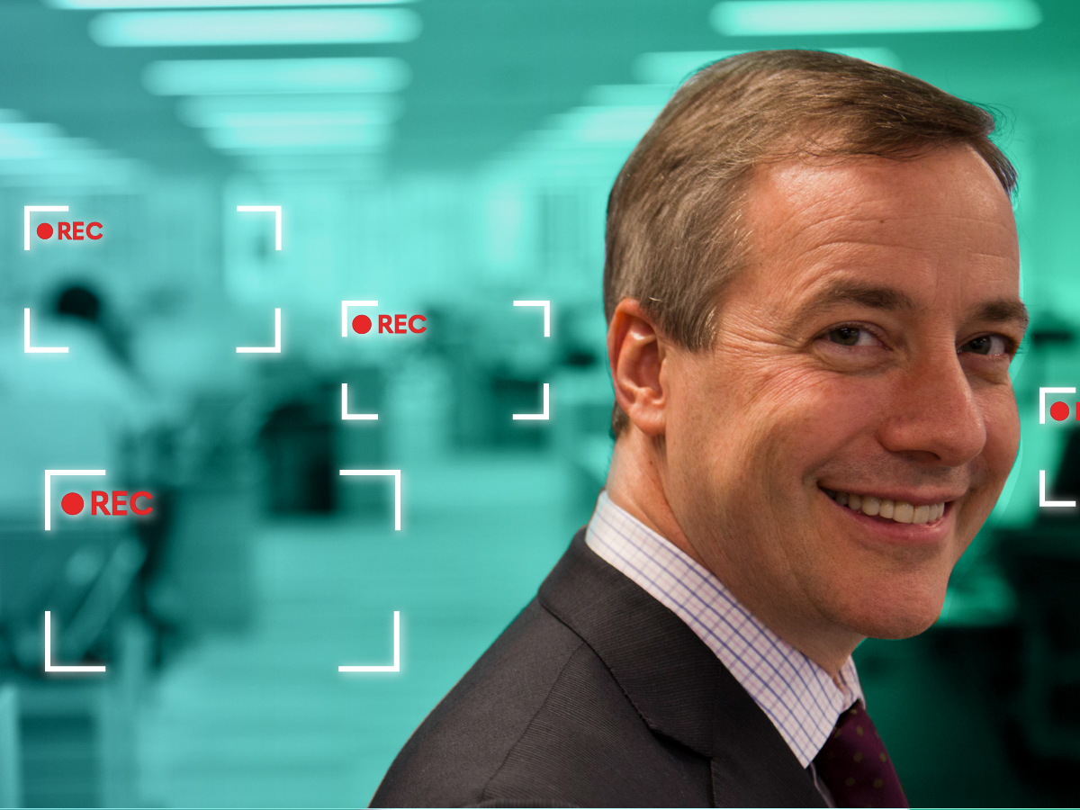 Costar CEO in front of office space with record frames surrounding the desks