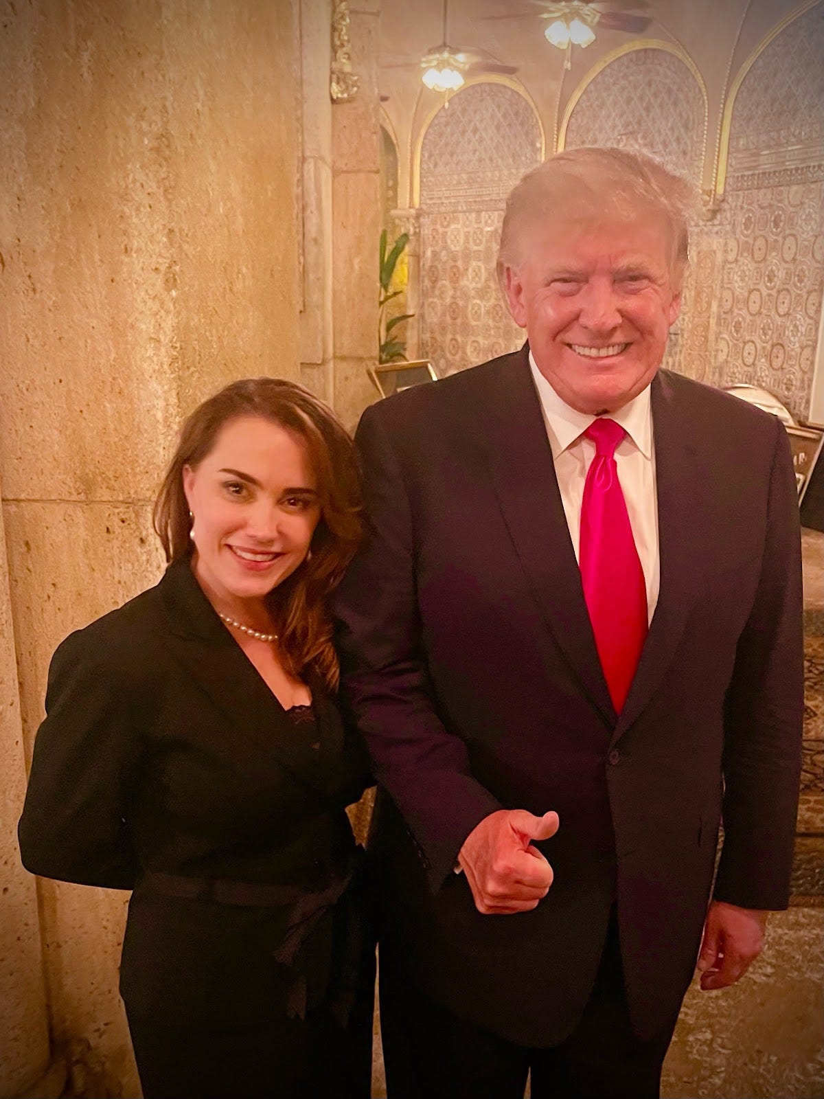 Deborah Adeimy, who is running for Congress in Florida, poses with former President Donald Trump at Mar-a-Lago.
