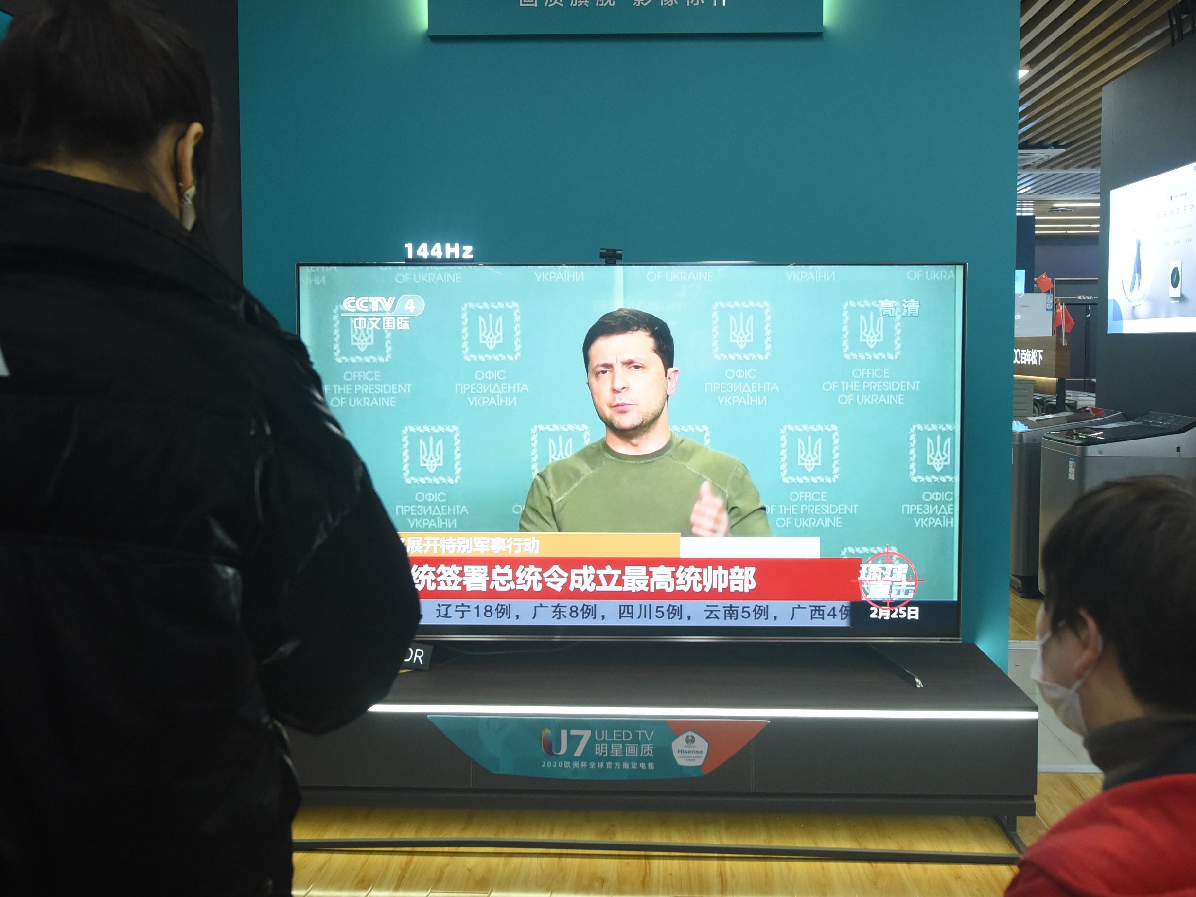 A Chinese citizen watches a news report on the conflict between Russia and Ukraine at an appliance store in Hangzhou, east China's Zhejiang Province, Feb 25, 2022. (Photo credit should read Costfoto/Future Publishing via Getty Images)