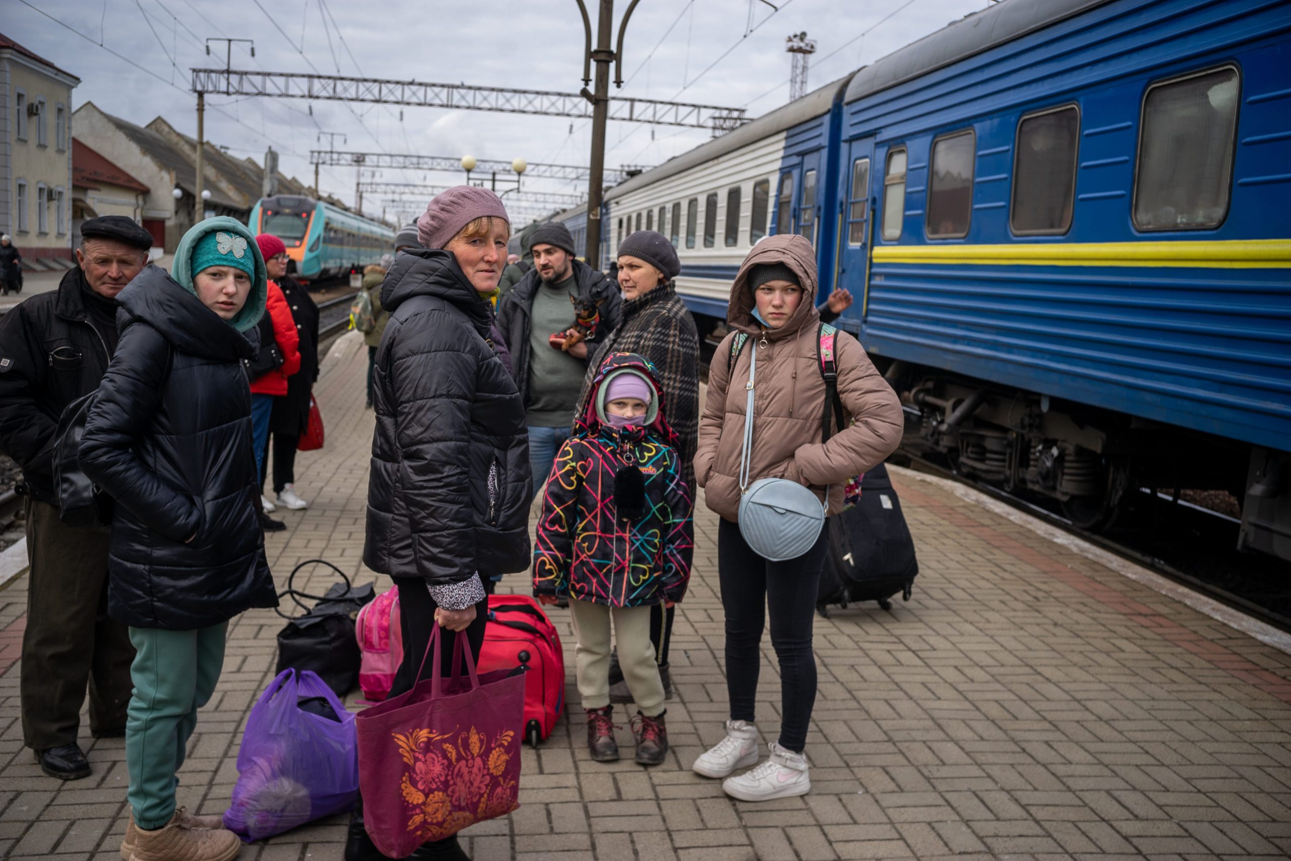 Family waits for train in Ukraine.