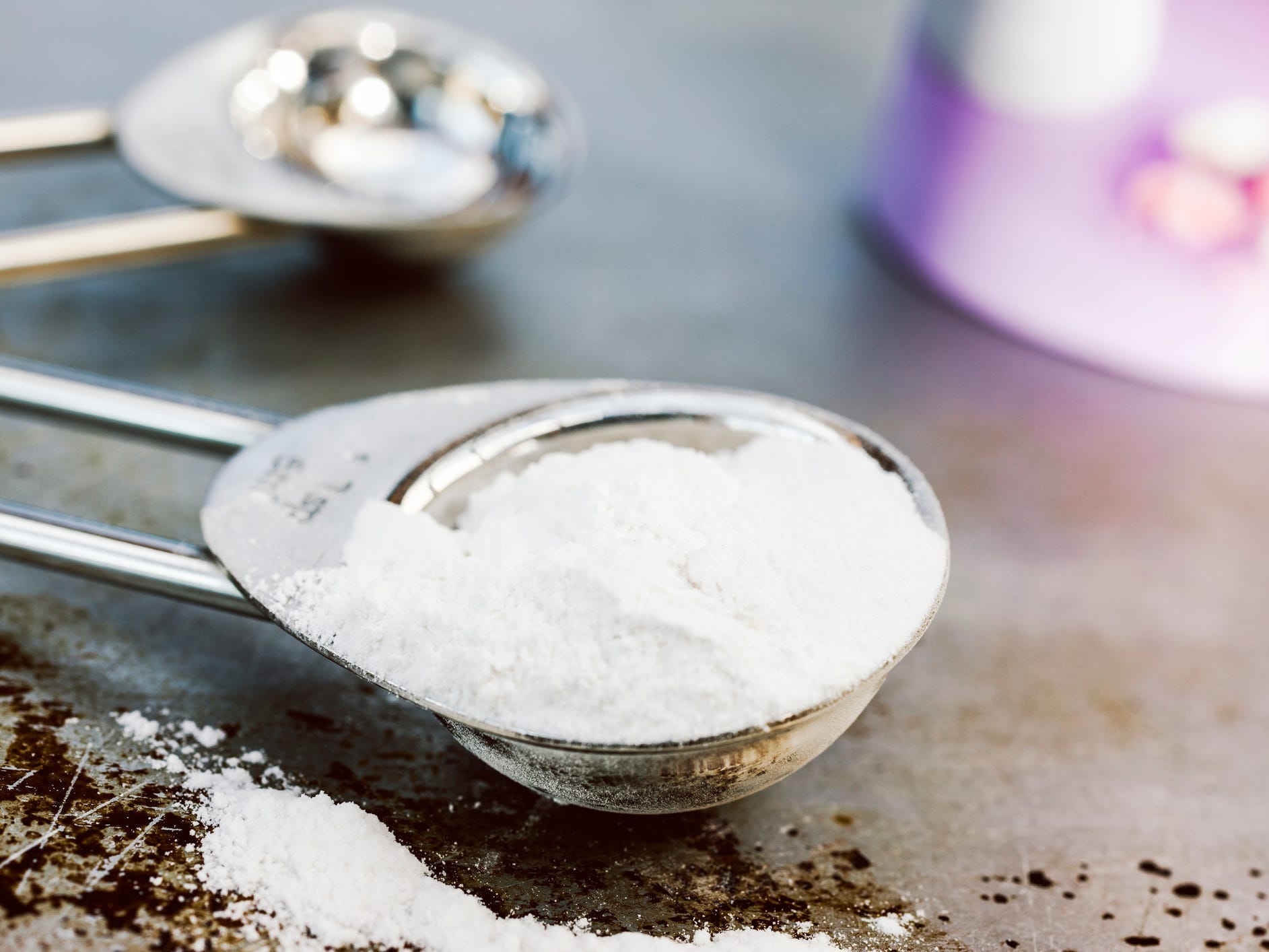 close up of baking soda in a measuring spoon