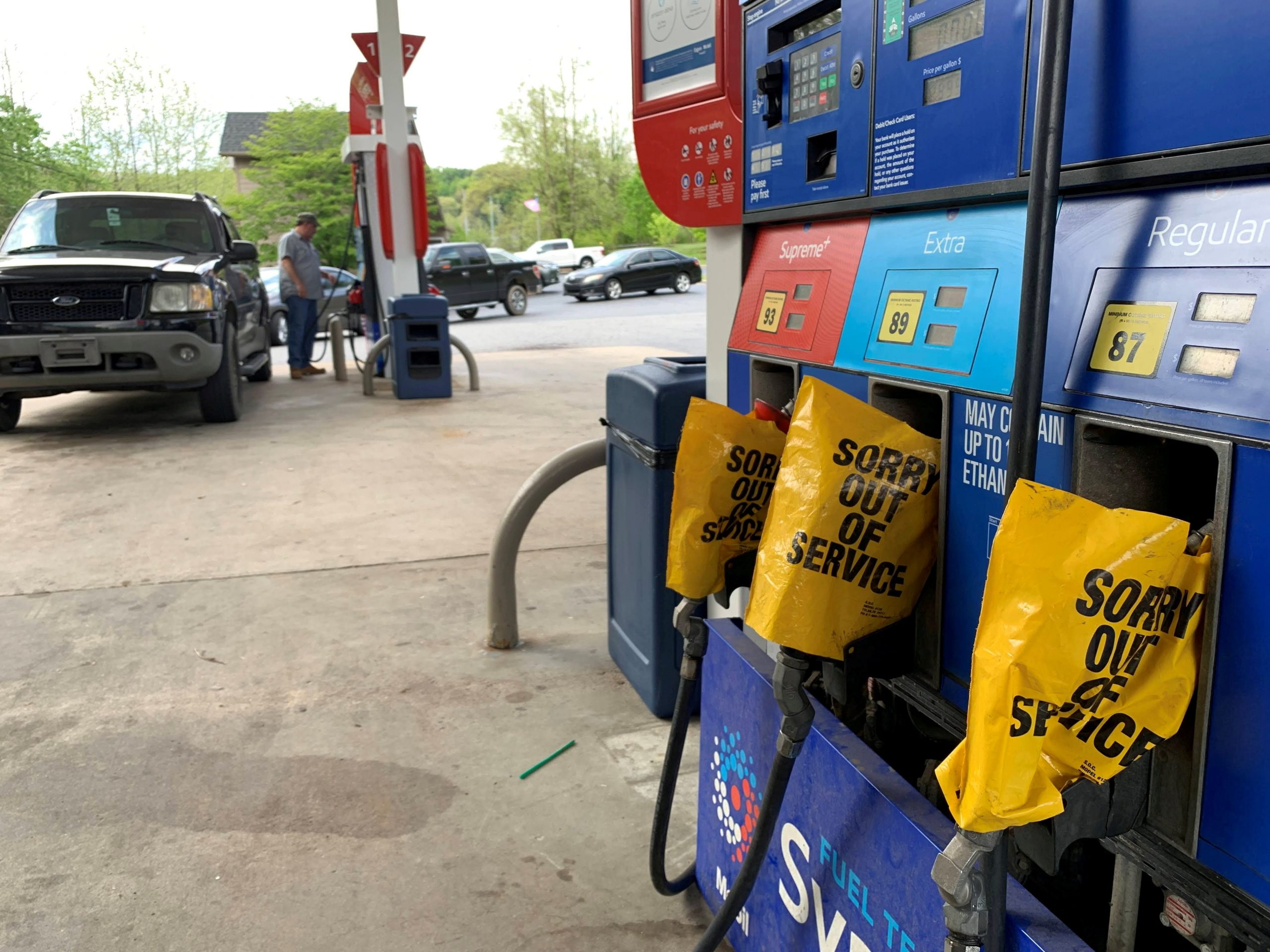 Out of service fuel nozzles are covered in plastic on a gas pump at a gas station in Waynesville, North Carolina, after a gasoline supply crunch caused by the Colonial Pipeline hack