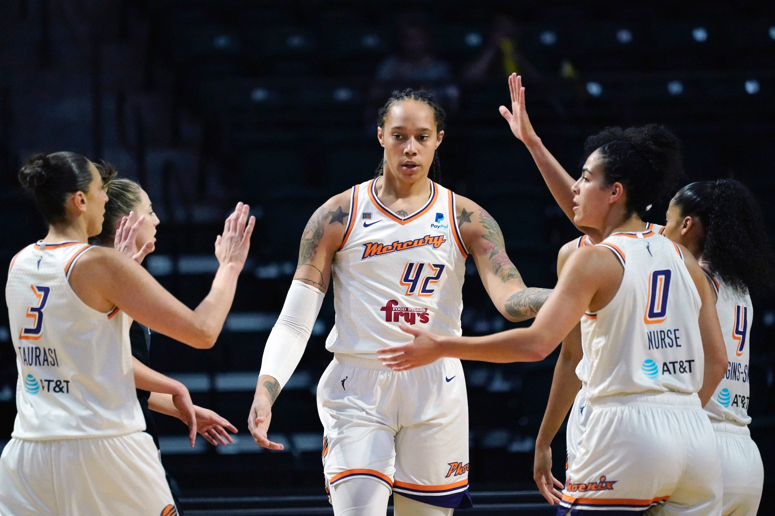 Brittney Griner high fives her Phoenix Mercury teammates.