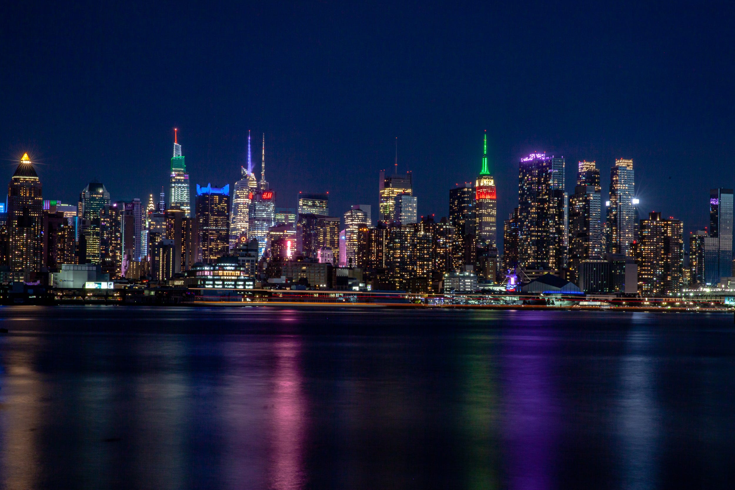 The NYC skyline lit up at night.