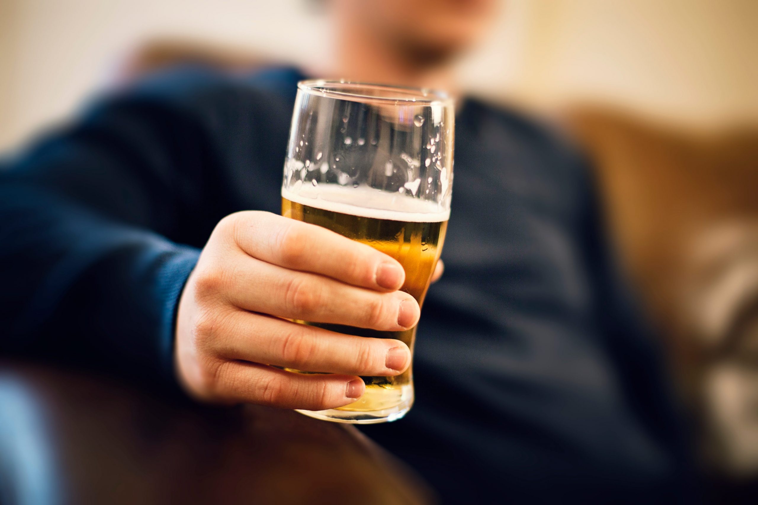 Man drinking pint of bear.