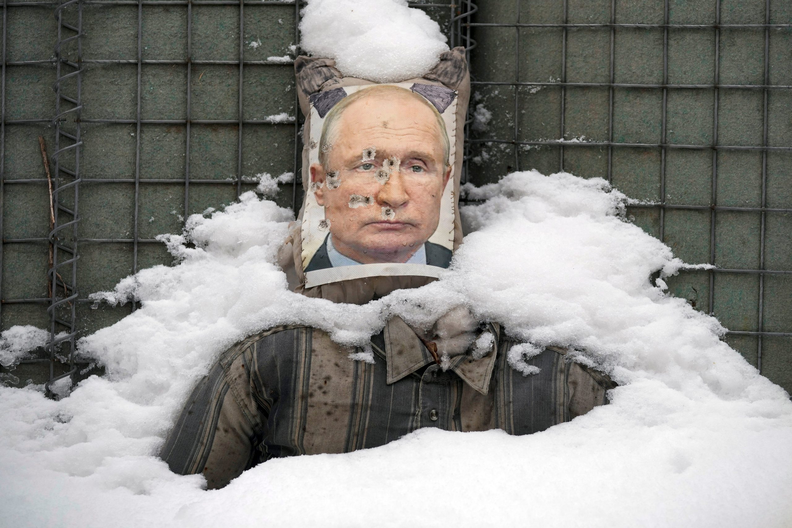 A bullet riddled effigy of Russian President Vladimir Putin, is coated by fresh snow at a frontline position in the Luhansk region, eastern Ukraine, Tuesday, Feb. 1, 2022.
