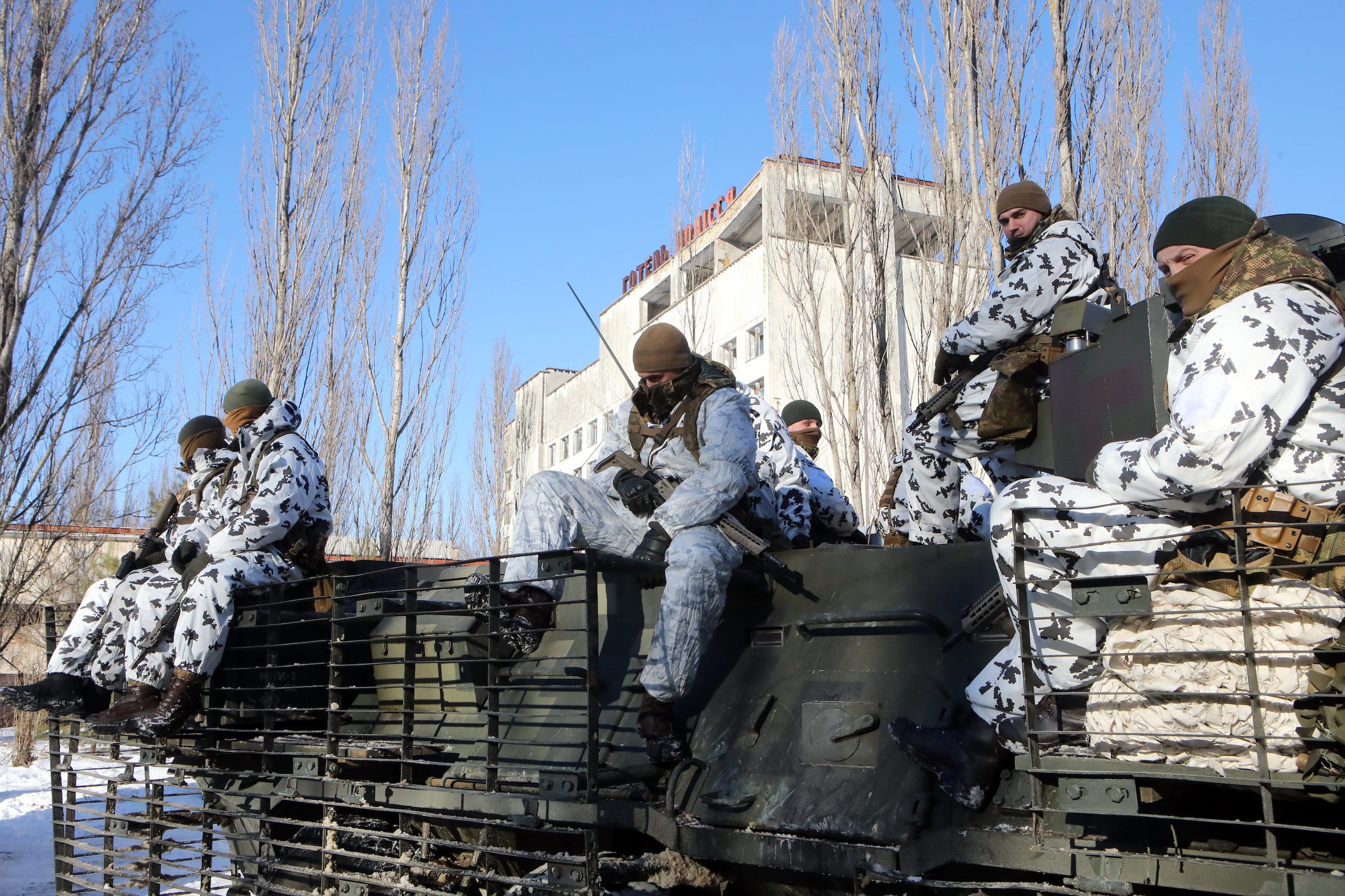 Soldiers sit inside the Chernobyl Exclusion Zone