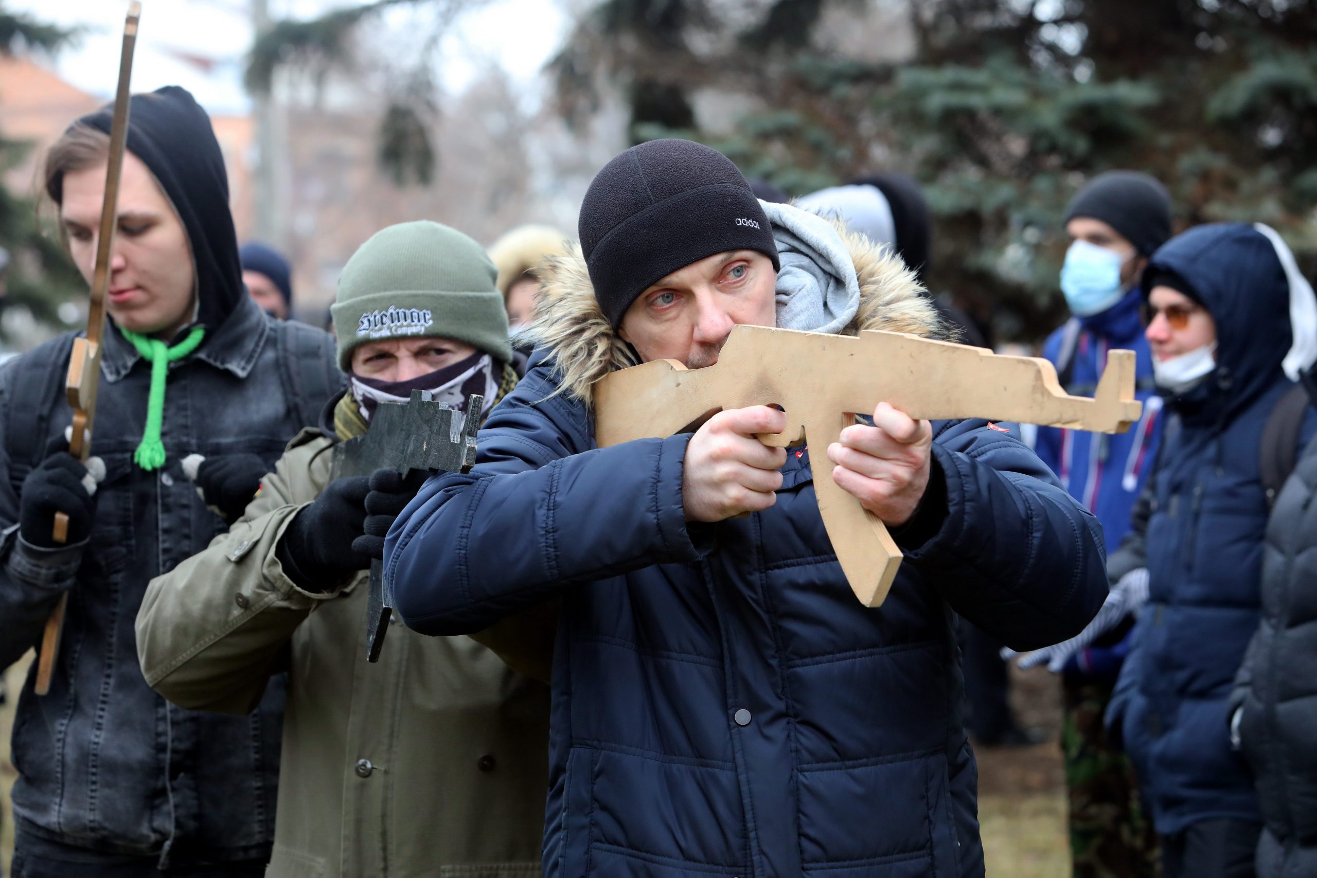 A man points a cutout of a rifle during the territorial defence drill for civilians given by Azov Regiment.