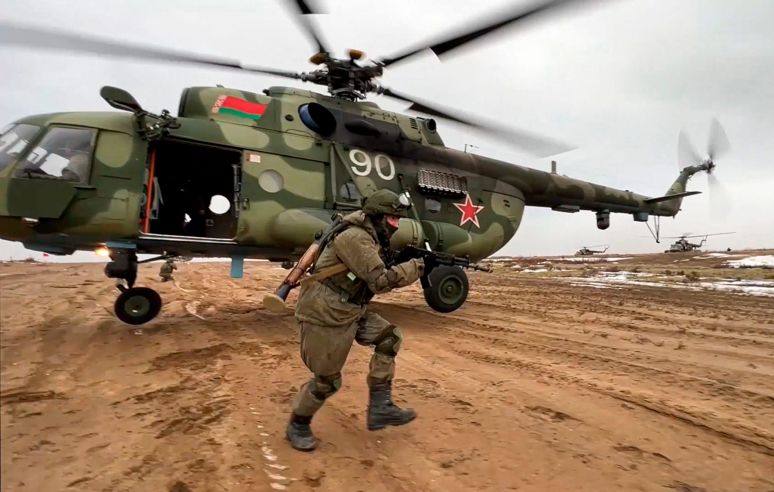 In this frame from video provided by the Russian Defense Ministry Press Service on Feb. 19, 2022, a Russian marine runs during the Union Courage-2022 Russia-Belarus military drills at the Obuz-Lesnovsky training ground in Belarus
