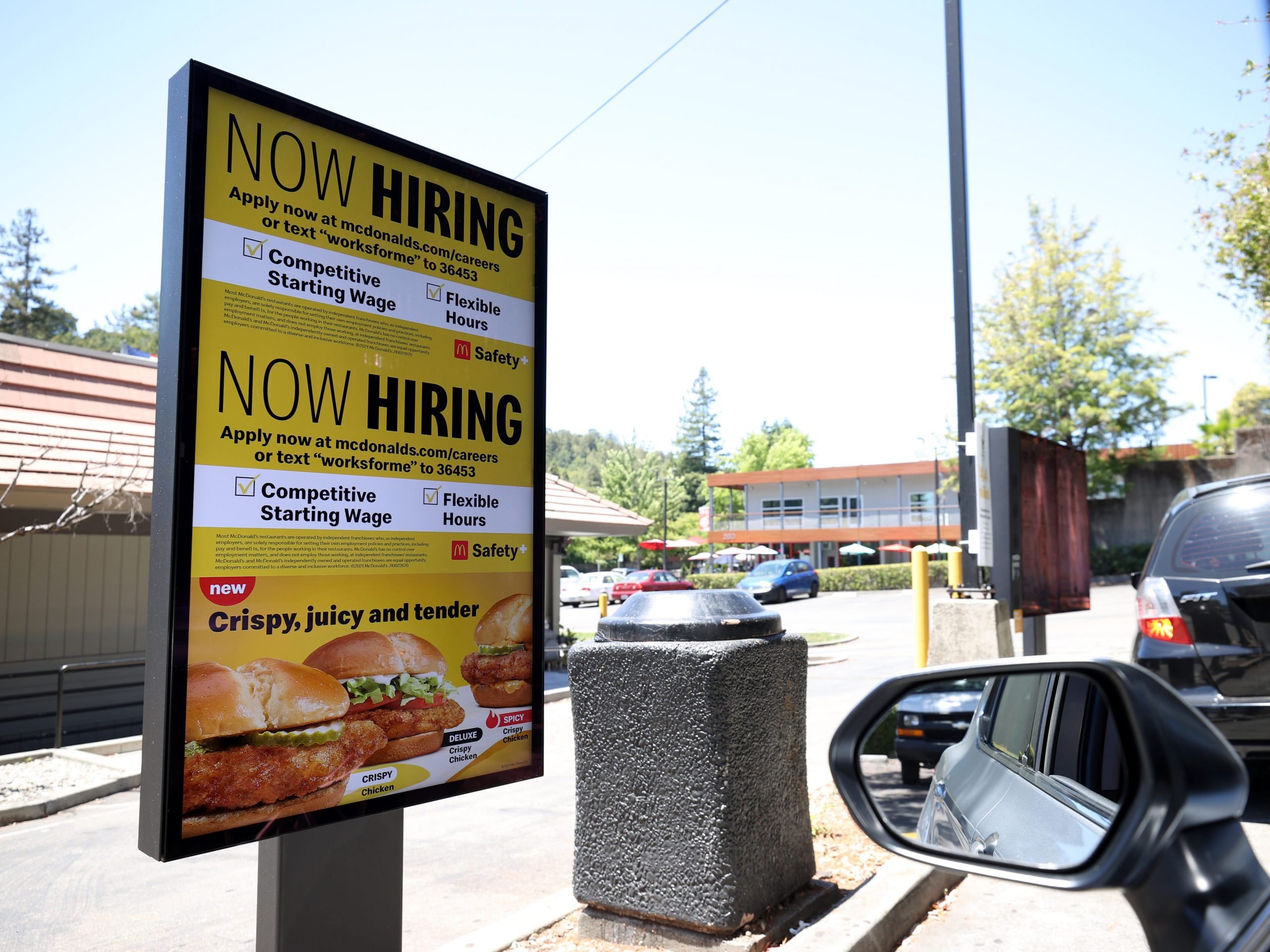 A "Now Hiring" sign is posted in the drive thru of a McDonald's restaurant on July 07, 2021 in San Rafael, California.