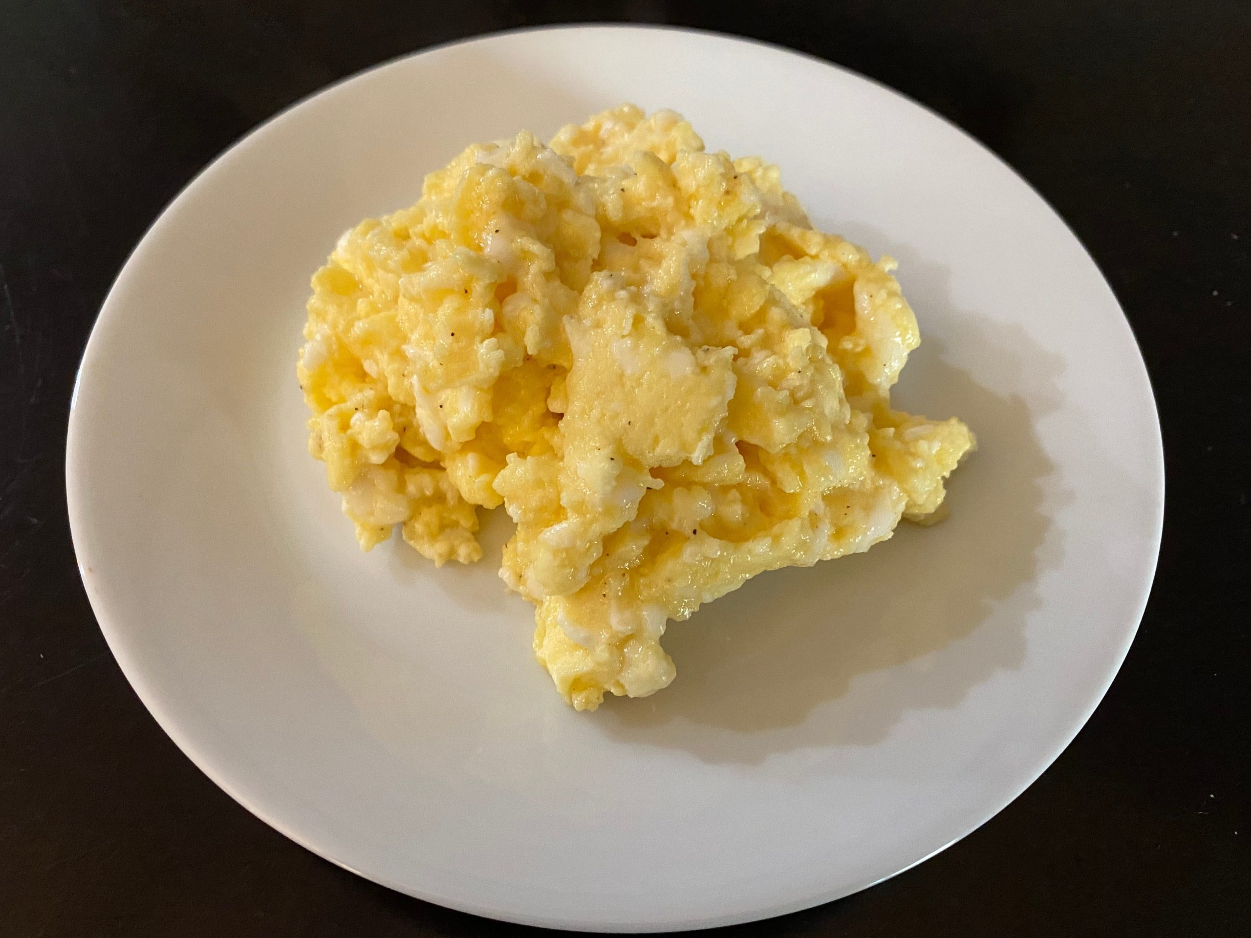 Scrambled eggs on a white plate