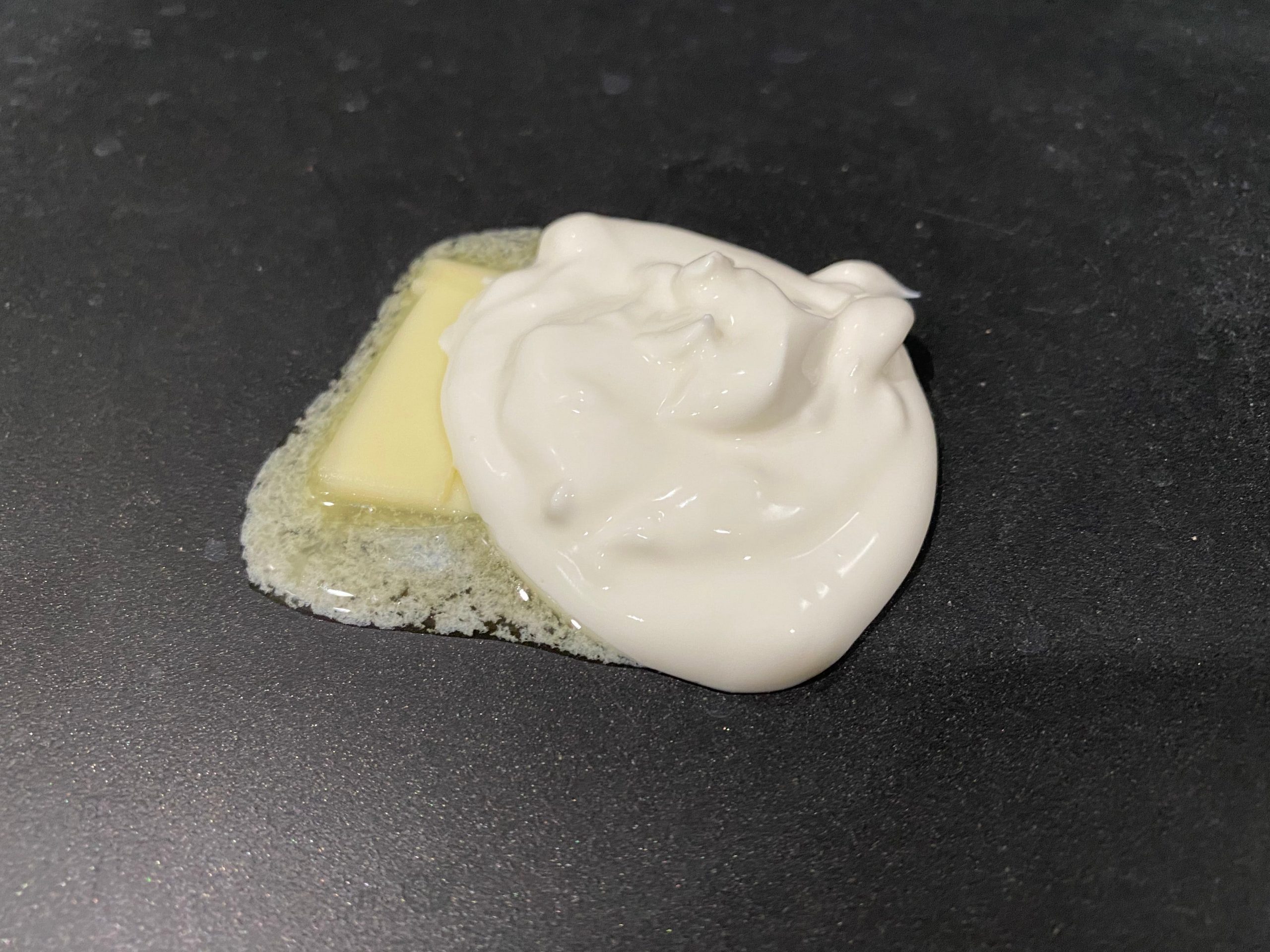 Pat of butter and dollop of sour cream in a pan