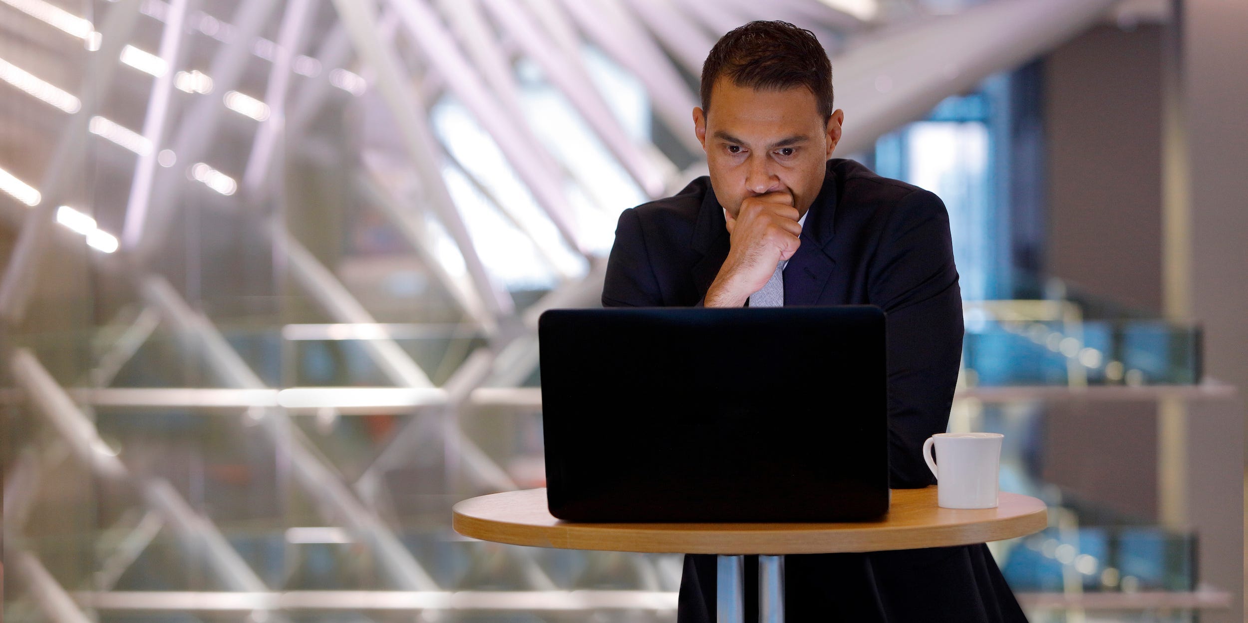 man looking at laptop computer confused concerned