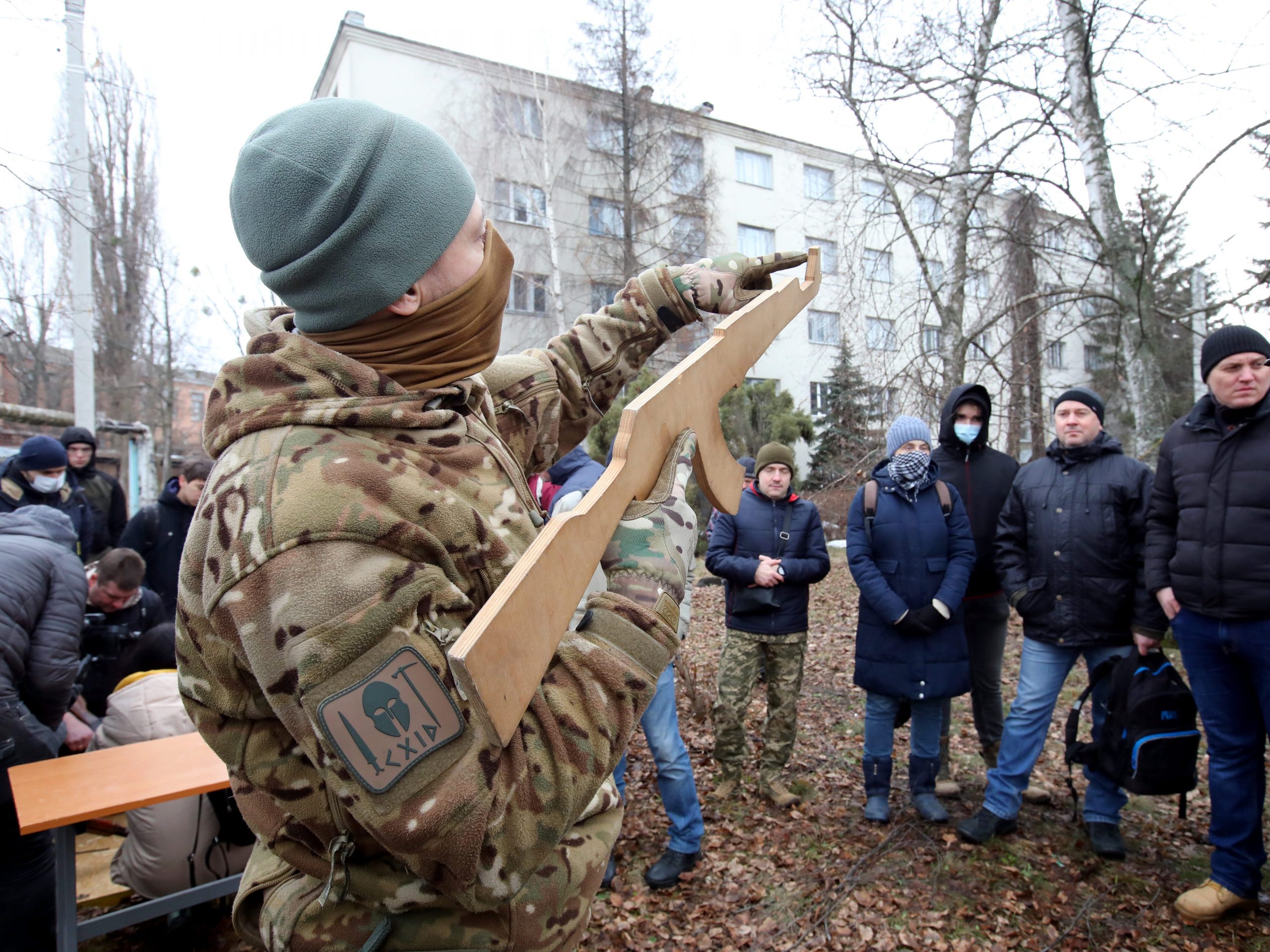 A man in a camouflage uniform holds a cutout of a firearm during the territorial defence drill for civilians given by Azov Regiment veterans.