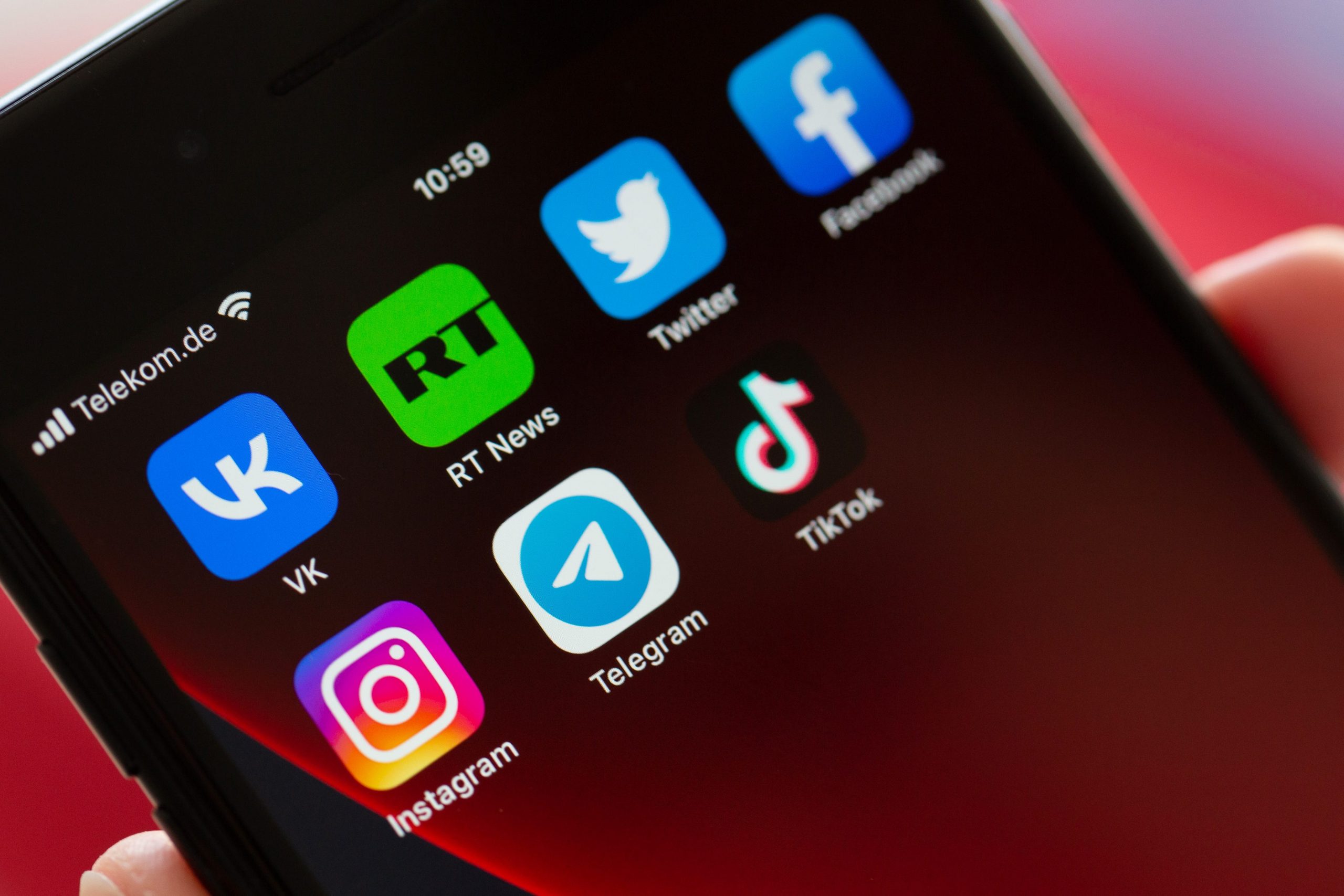 TikTok (rightmost icon in the second row) has said that it would ban Russia-backed news outlets such as RT (icon in the first row, second from left) from its platform in the EU. In this picture, the screen of a smartphone shows the logos of the apps VKontakte, Twitter, RT News, Facebook, Instagram, Telegram and TikTok