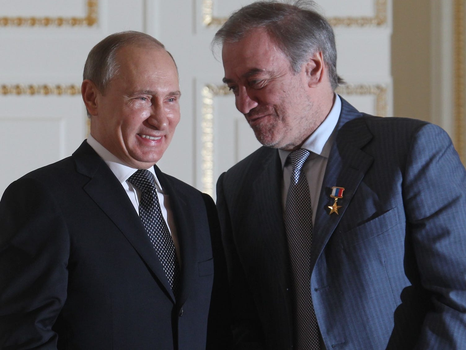 Valery Gergiev and Vladimir Putin are pictured talking together.