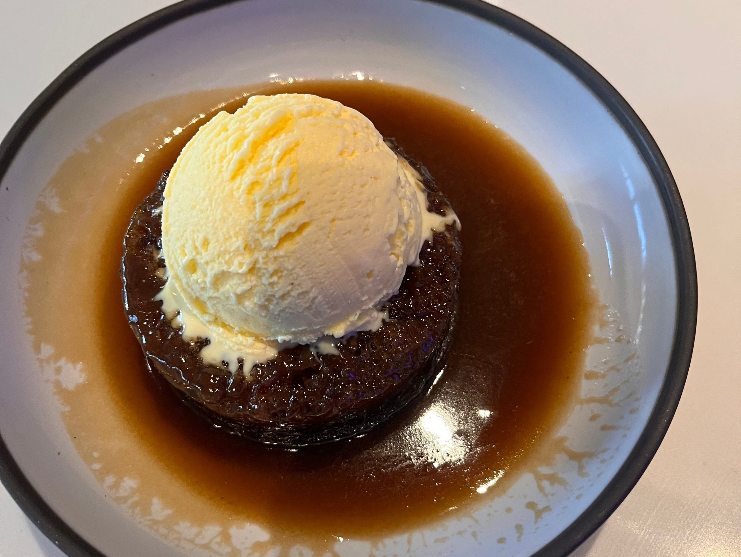 Sticky toffee pudding with vanilla ice cream on top