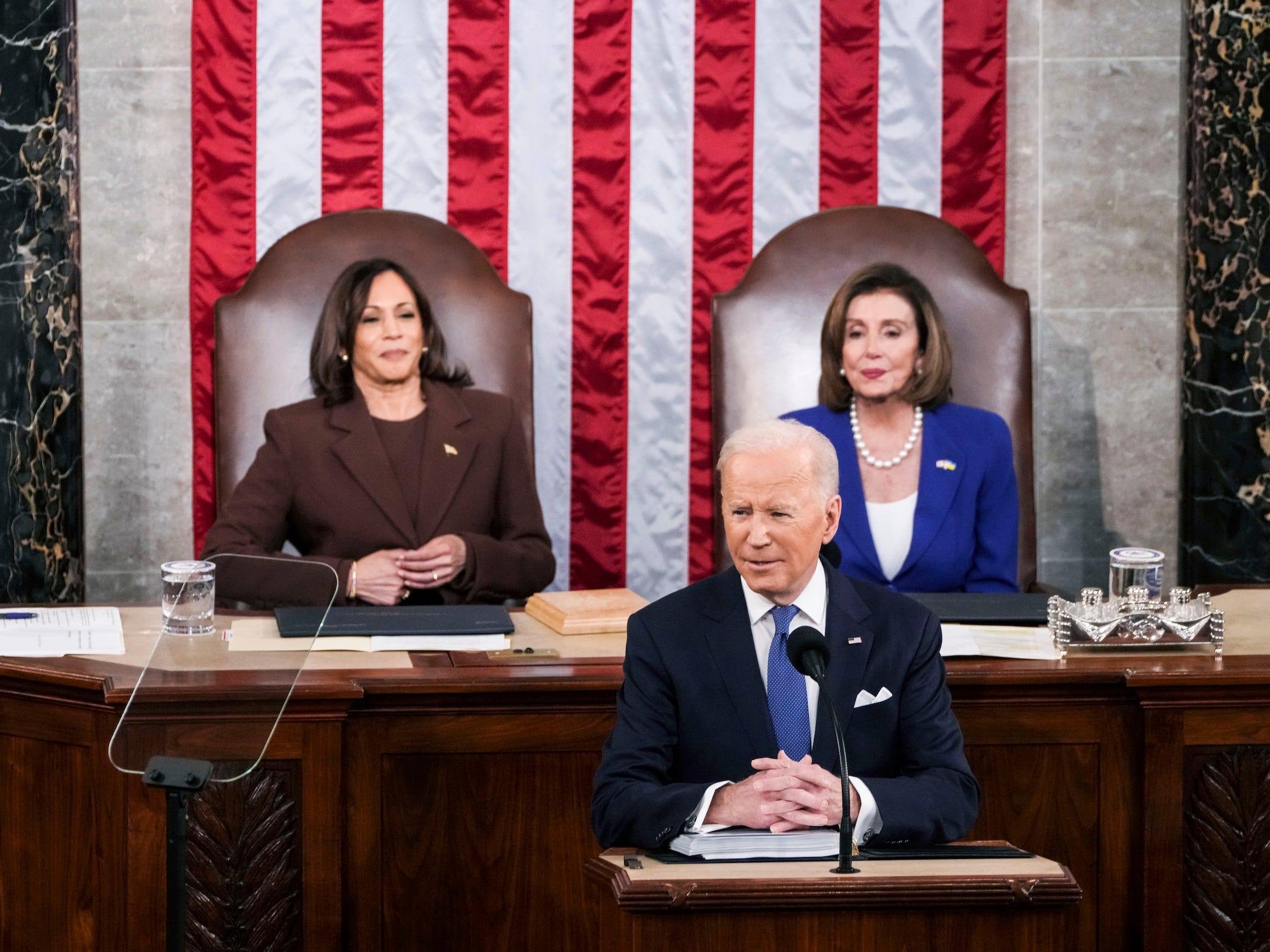 President Joe Biden delivers his first State of the Union address to a joint session of Congress at the Capitol, Tuesday, March 1, 2022, in Washington, as Vice President Kamala Harris and Speaker of the House Nancy Pelosi of California, look on.