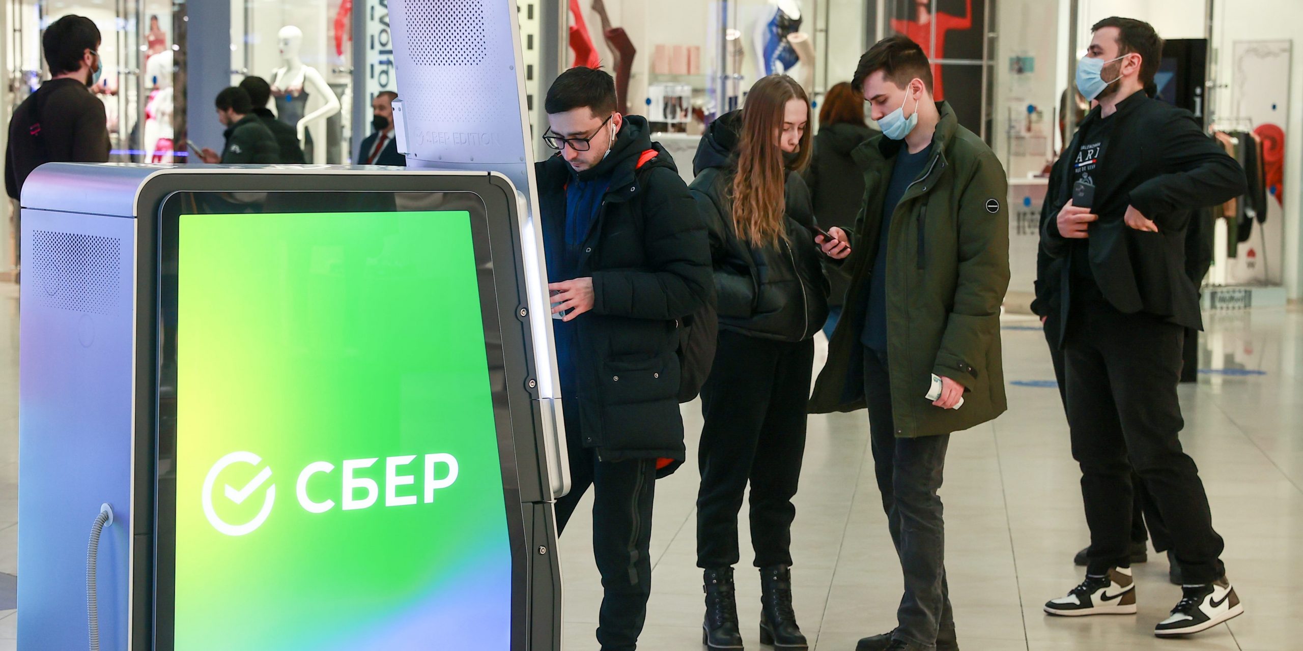 People queue at an ATM in Moscow, Russia.