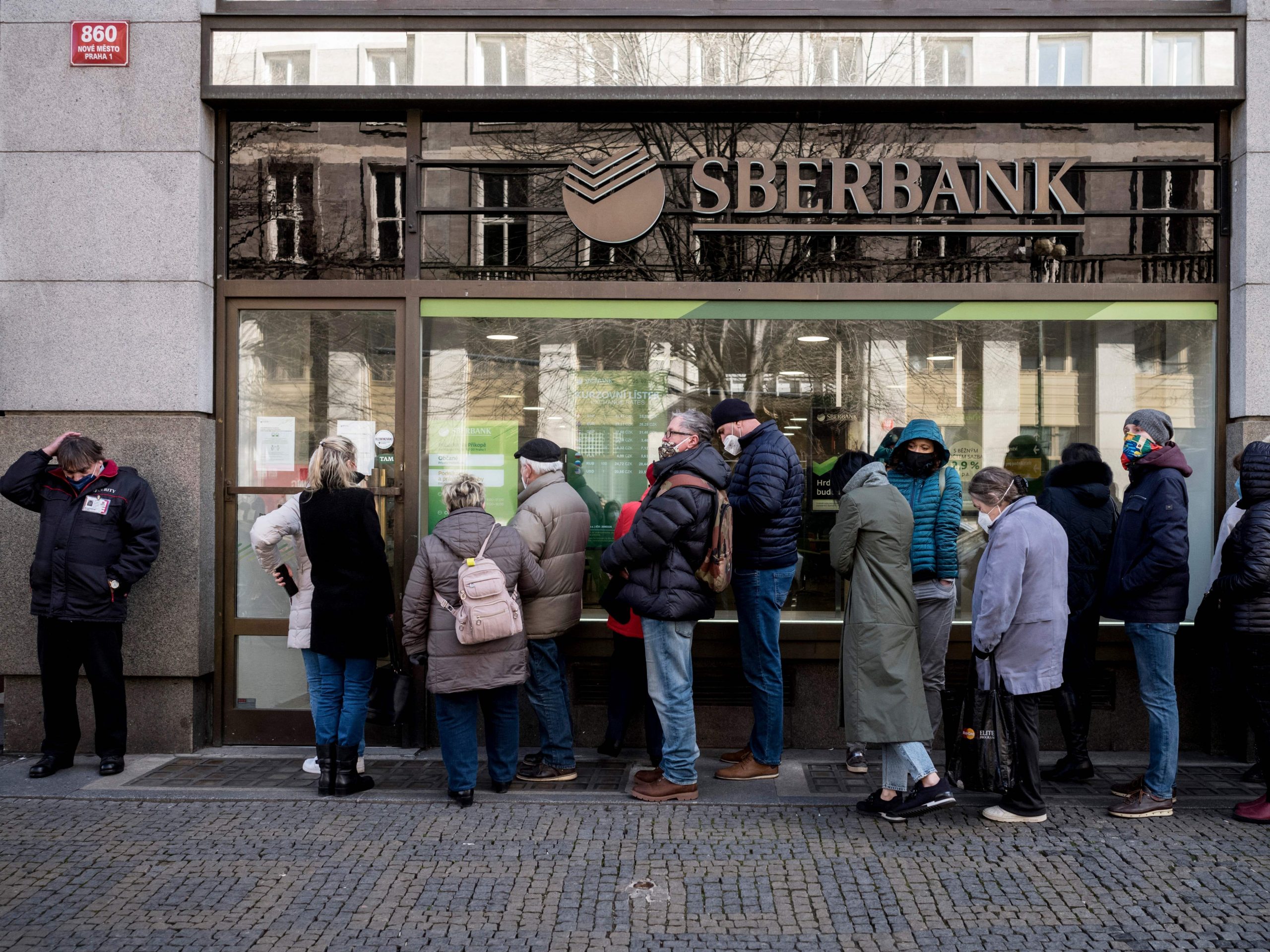 People queue outside a branch of Russian state-owned bank Sberbank to withdraw their savings and close their accounts following Russia's attack on Ukraine.