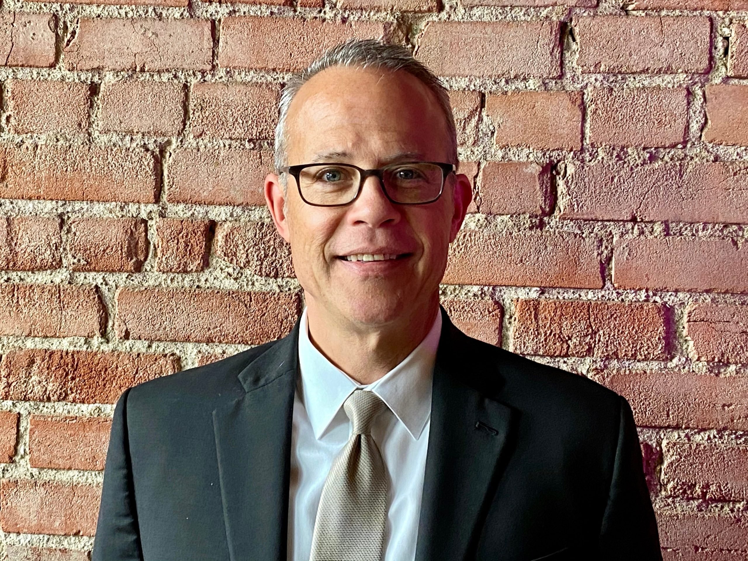 headshot of Mike Patterson in front of brick wall