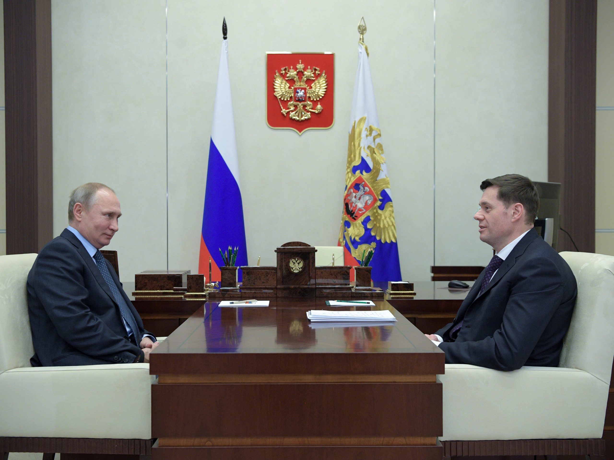 De Russische president Vladimir Poetin (L) en Severstal-bestuursvoorzitter Alexei Mordasjov tijdens een vergadering in 2018 in Moskou.