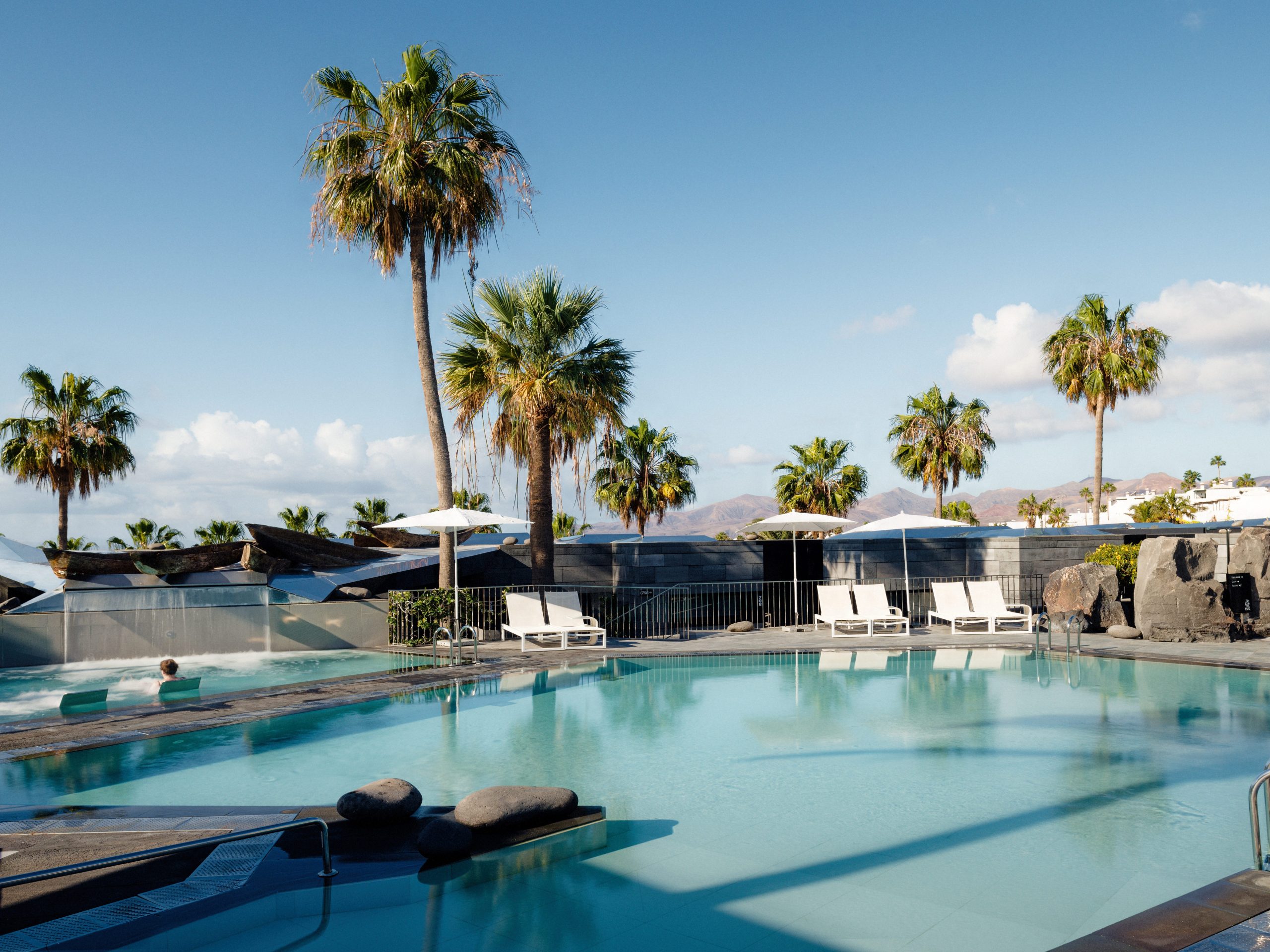 The pool with palm trees at Hotel La Isla y El Mar in Lanzarote, Canary Islands