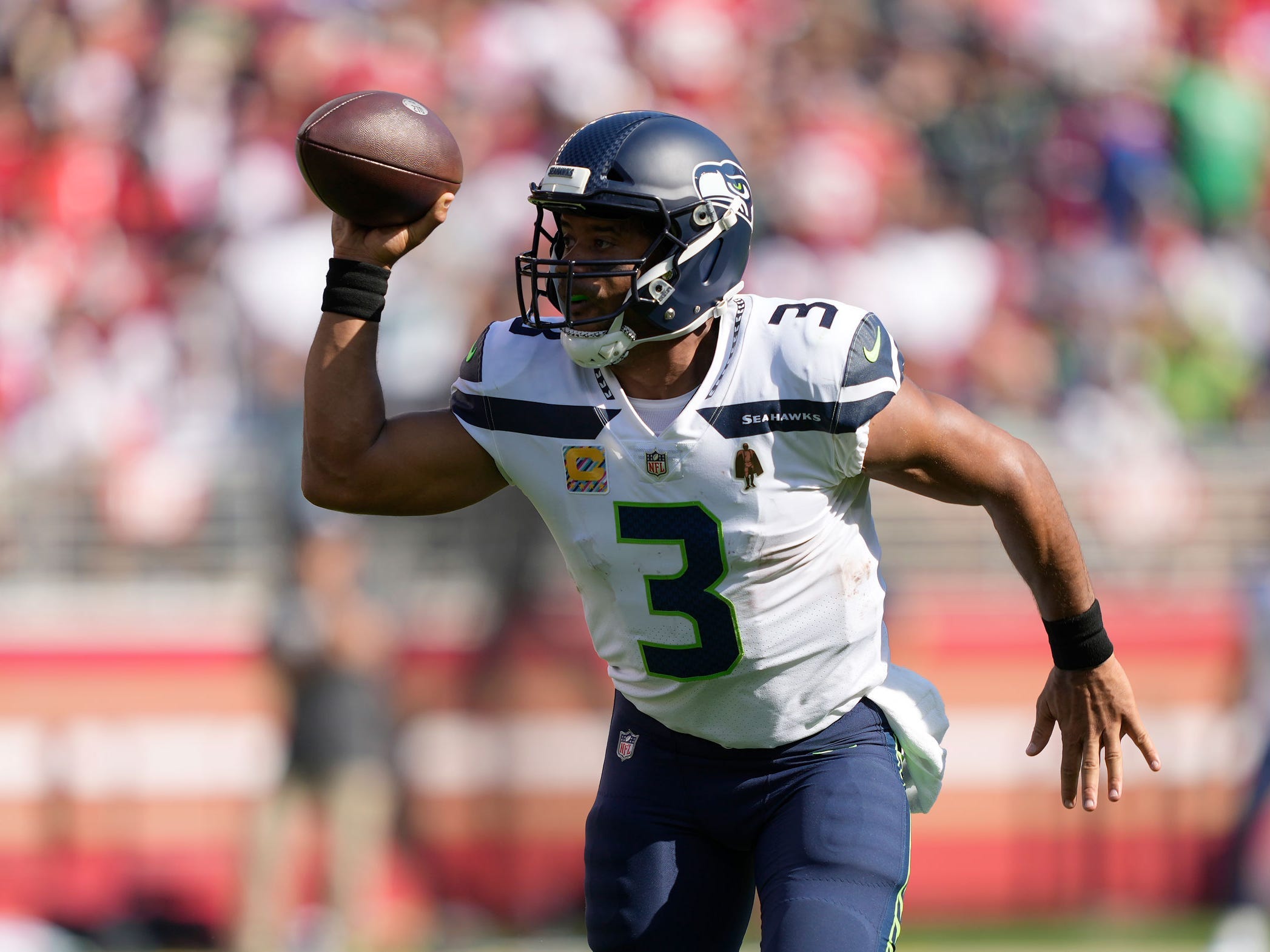 Russell Wilson makes a play against the San Francisco 49ers.