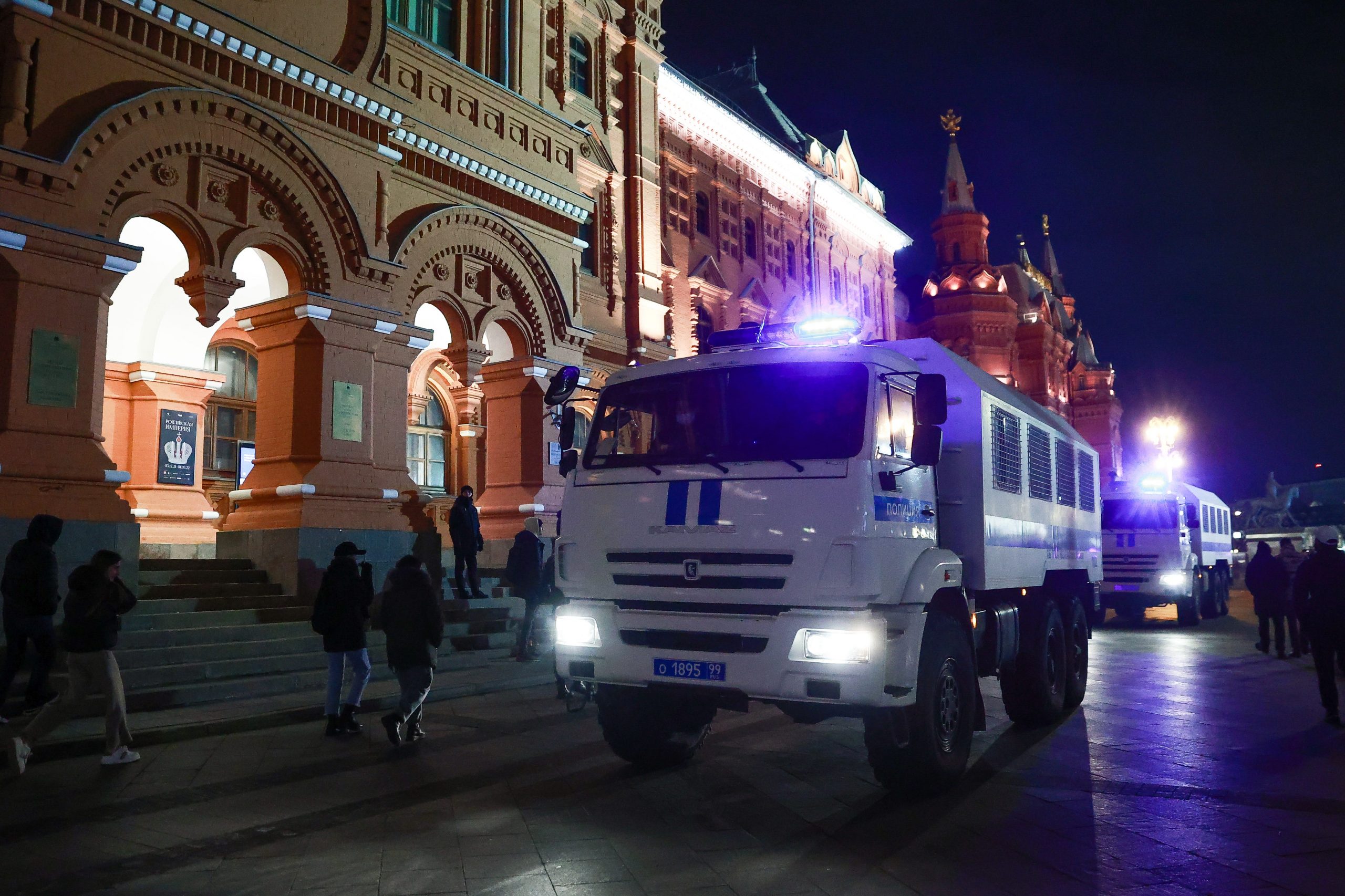 A police vehicle on a street in Moscow at night, during an unauthorized protest.