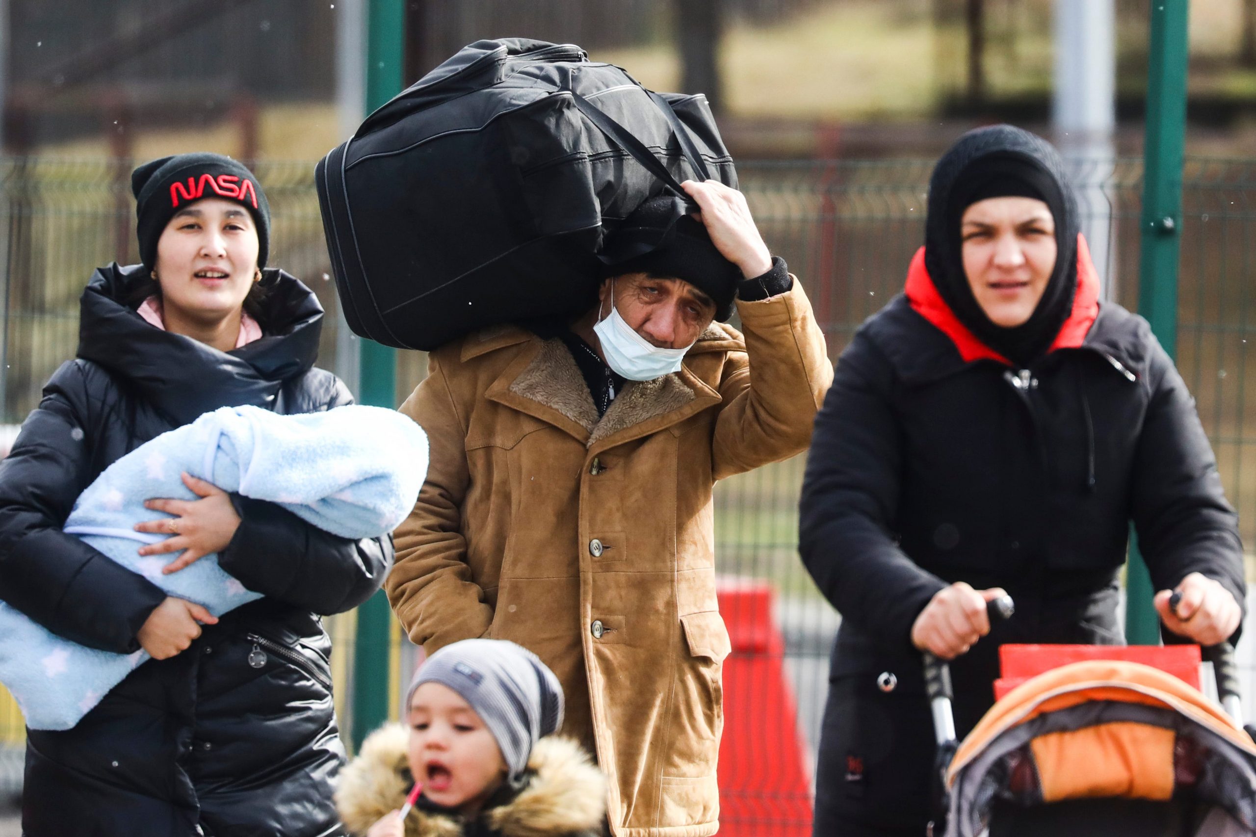 People with bags and luggage fleeing from Ukraine are seen after crossing Ukrainian-Polish border due to Russian military attack on Ukraine.