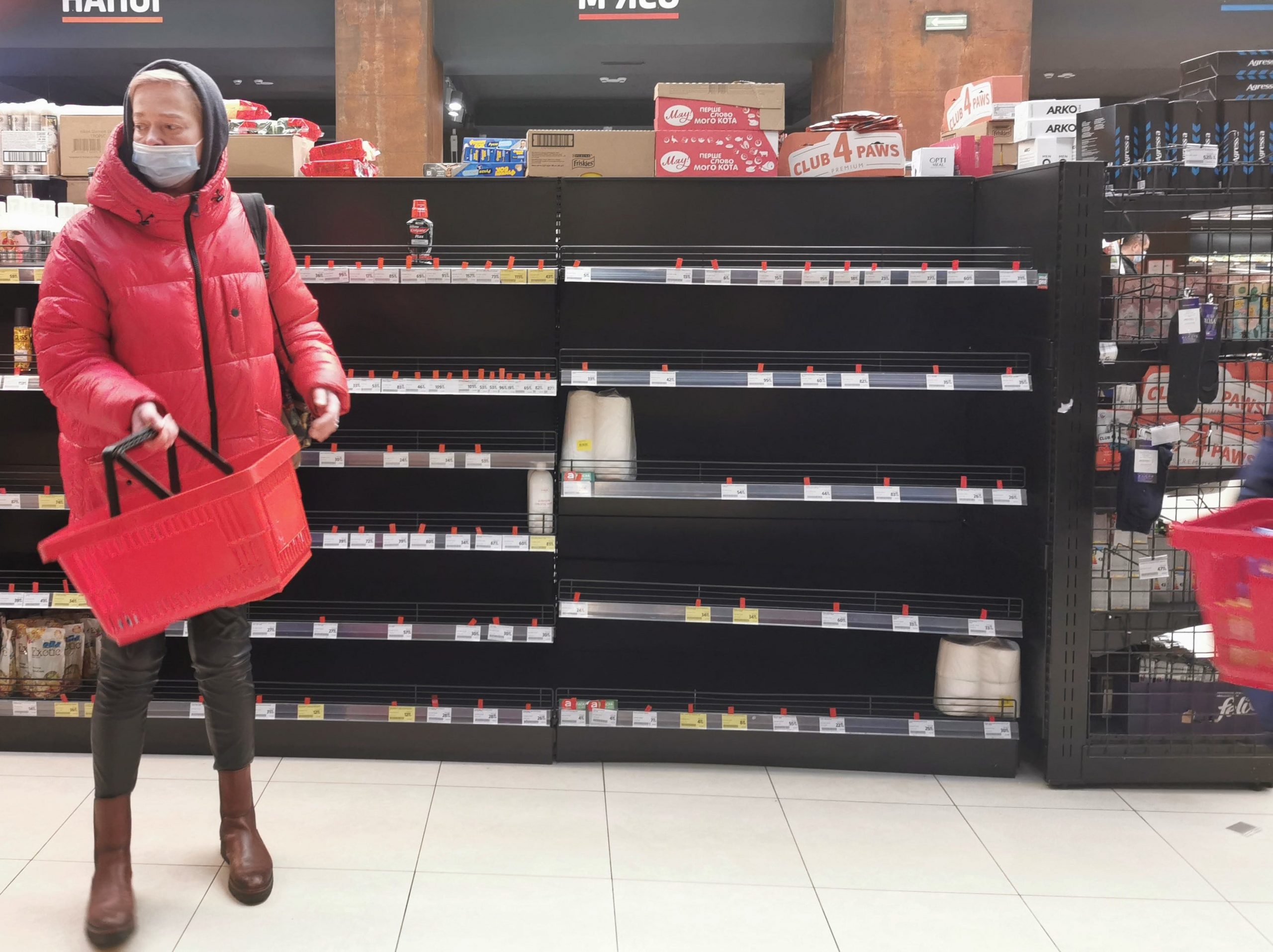 A woman goes shopping at a supermarket in Lviv, Ukraine, Feb. 28, 2022, when many storable food products were sold out.