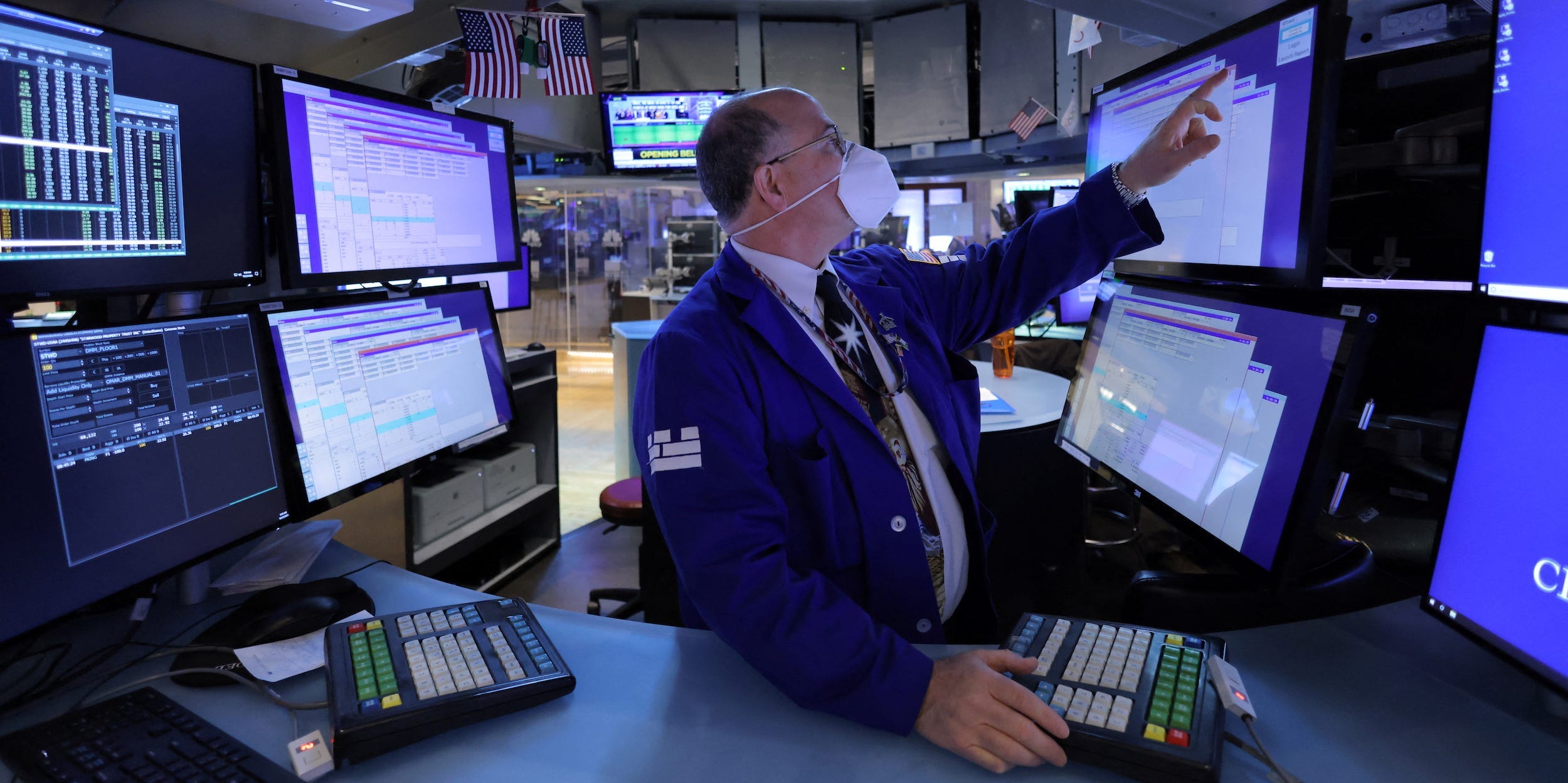 Trader points at screen at NYSE
