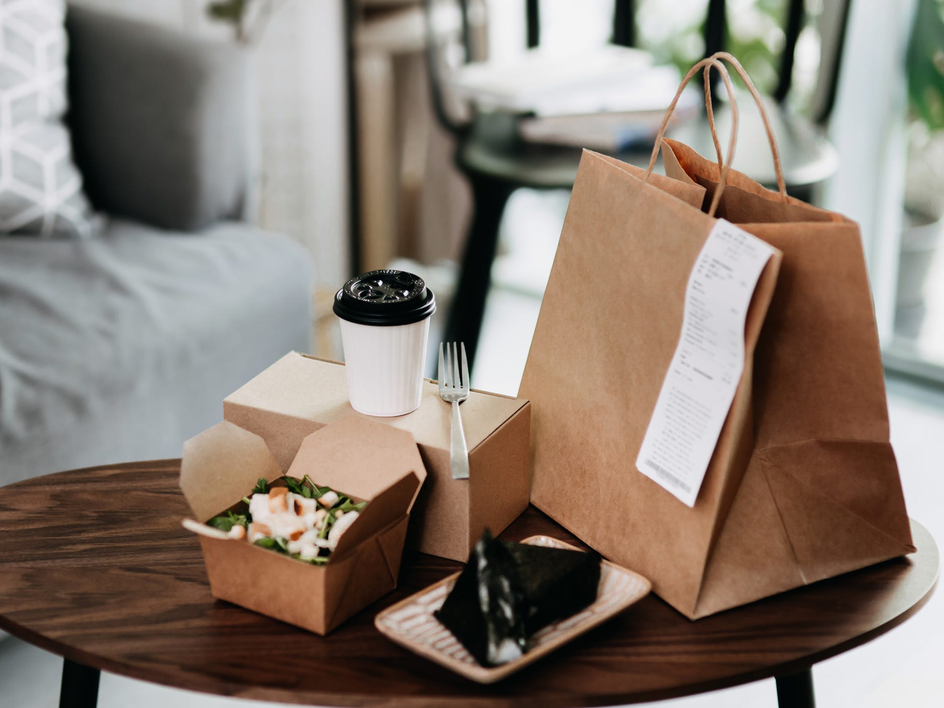 Takeout containers and bag on a round table