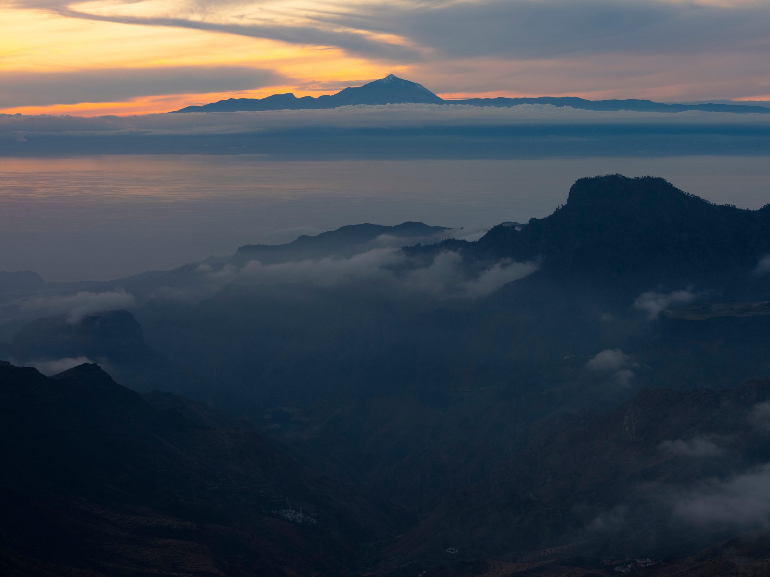 A misty mountain visa at sunset.