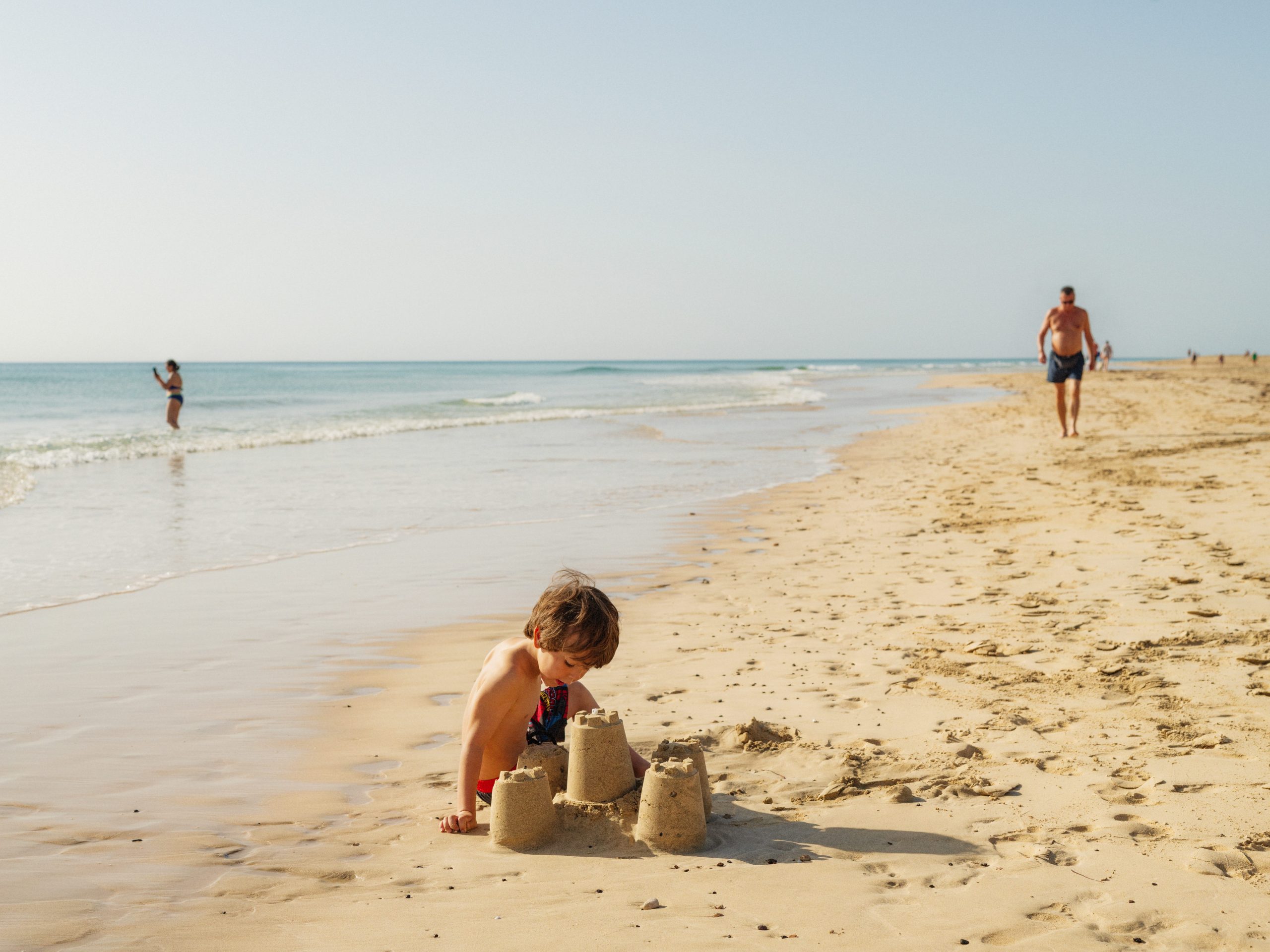 A child playing on the beach on Fuerteventura, Canary Islands.