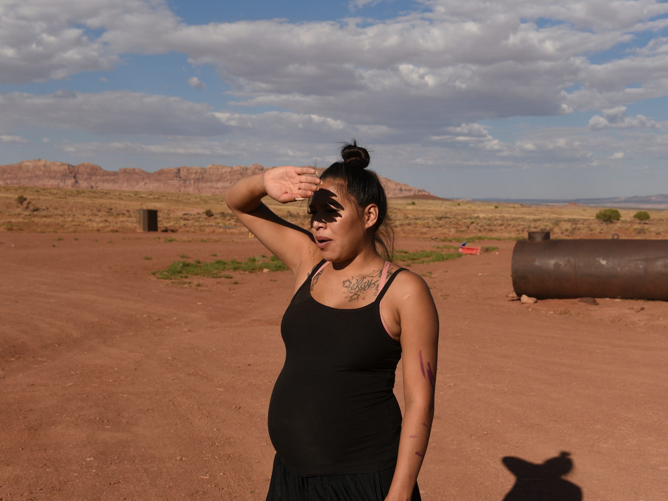 pregnant woman wearing black shades eyes from the sun in arizona desert