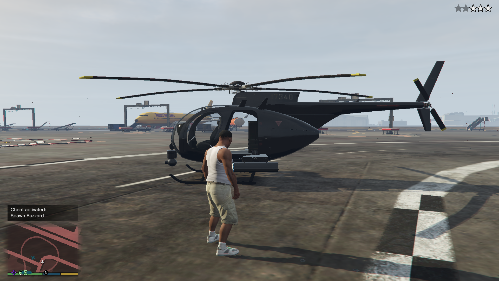 A screenshot from Grand Theft Auto 5, showing the character Franklin standing in front of a helicopter.