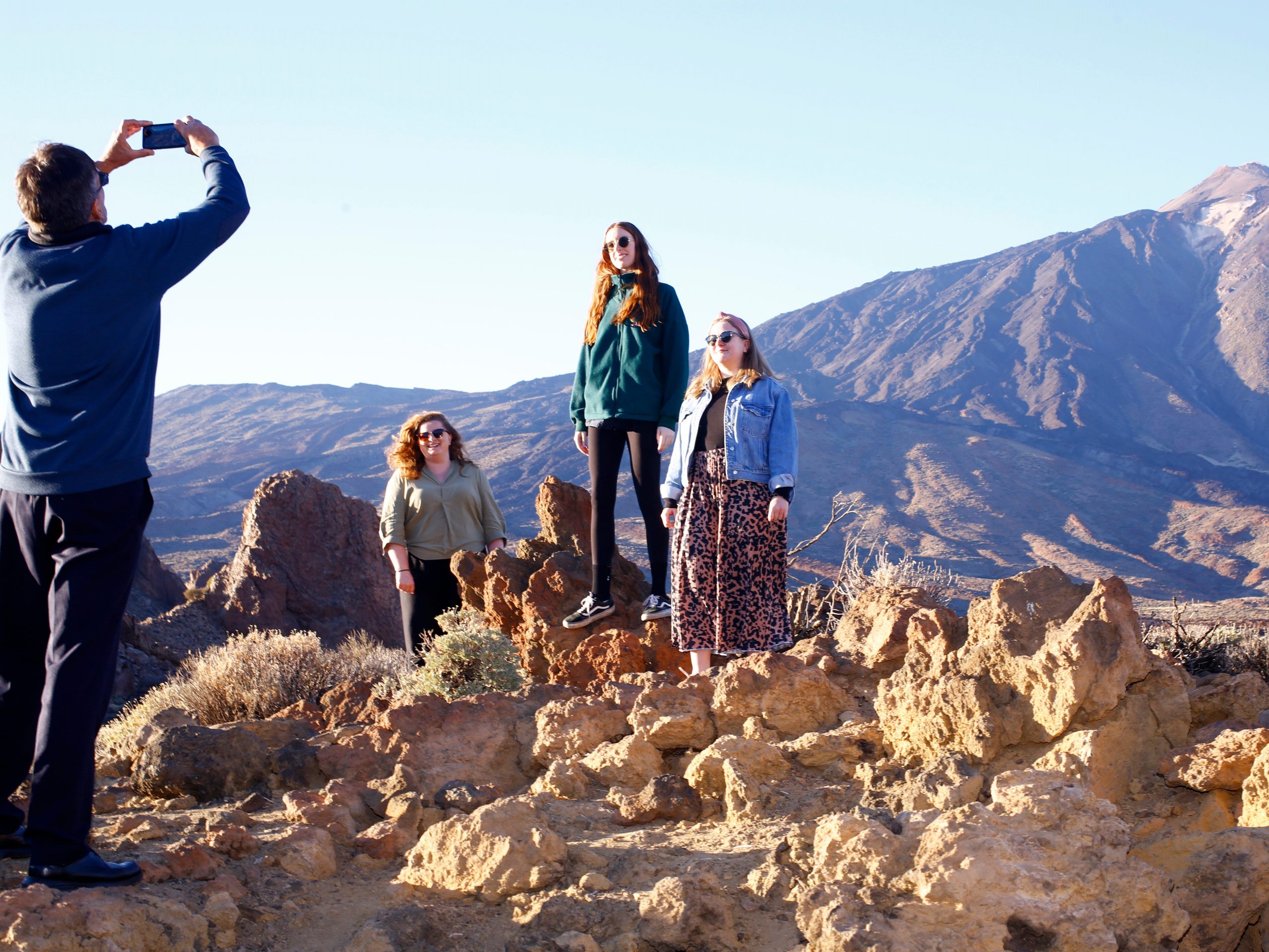 People posing at Teide volcano in Tenerife, Canary Islands.