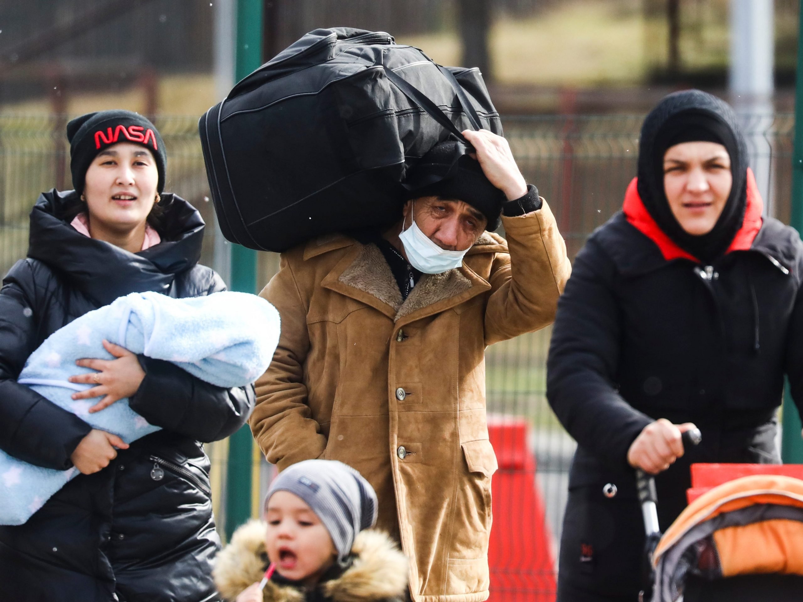 People with bags and luggage fleeing from Ukraine are seen after crossing Ukrainian-Polish border due to Russian military attack on Ukraine.