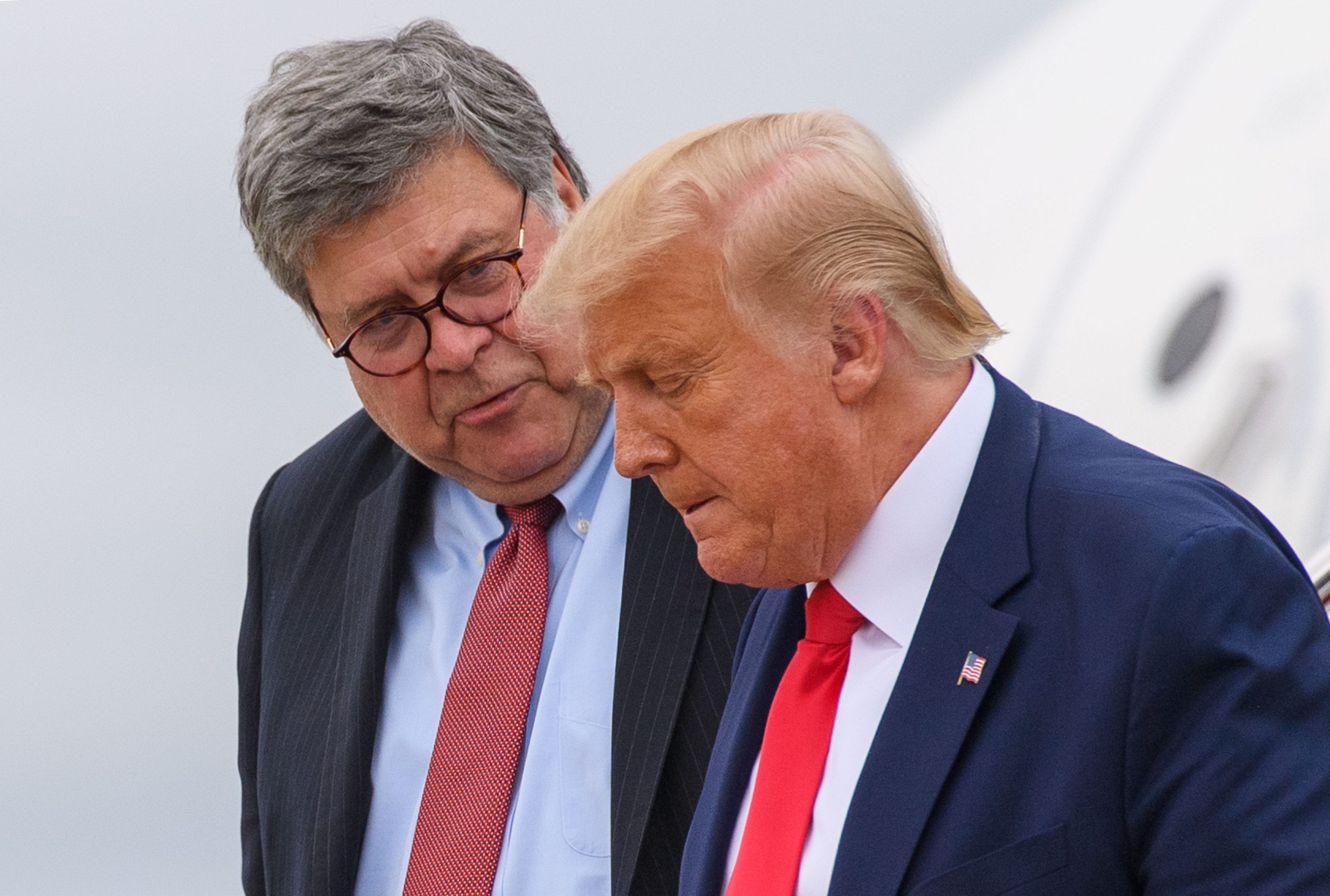 US President Donald Trump (R) and US Attorney General William Barr step off Air Force One upon arrival at Andrews Air Force Base in Maryland on September 1, 2020