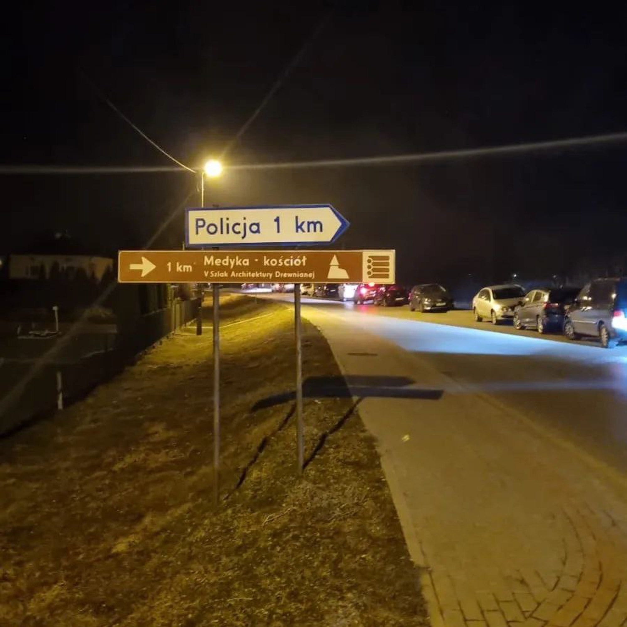 A sign for the Polish border town of Medyka at night