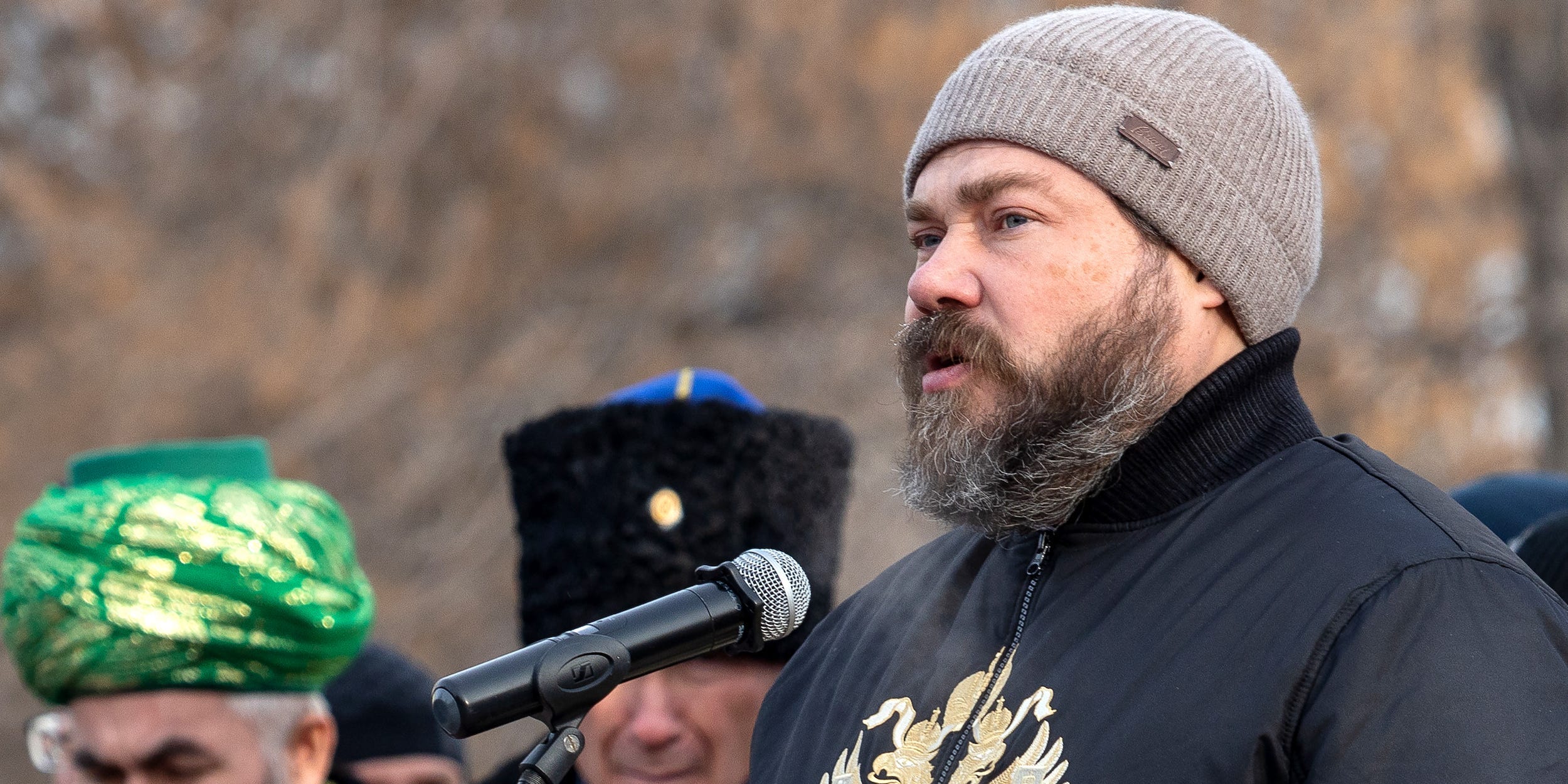 Russian oligarch Konstantin Malofeyev wears a grey winter cap and a black jacket.