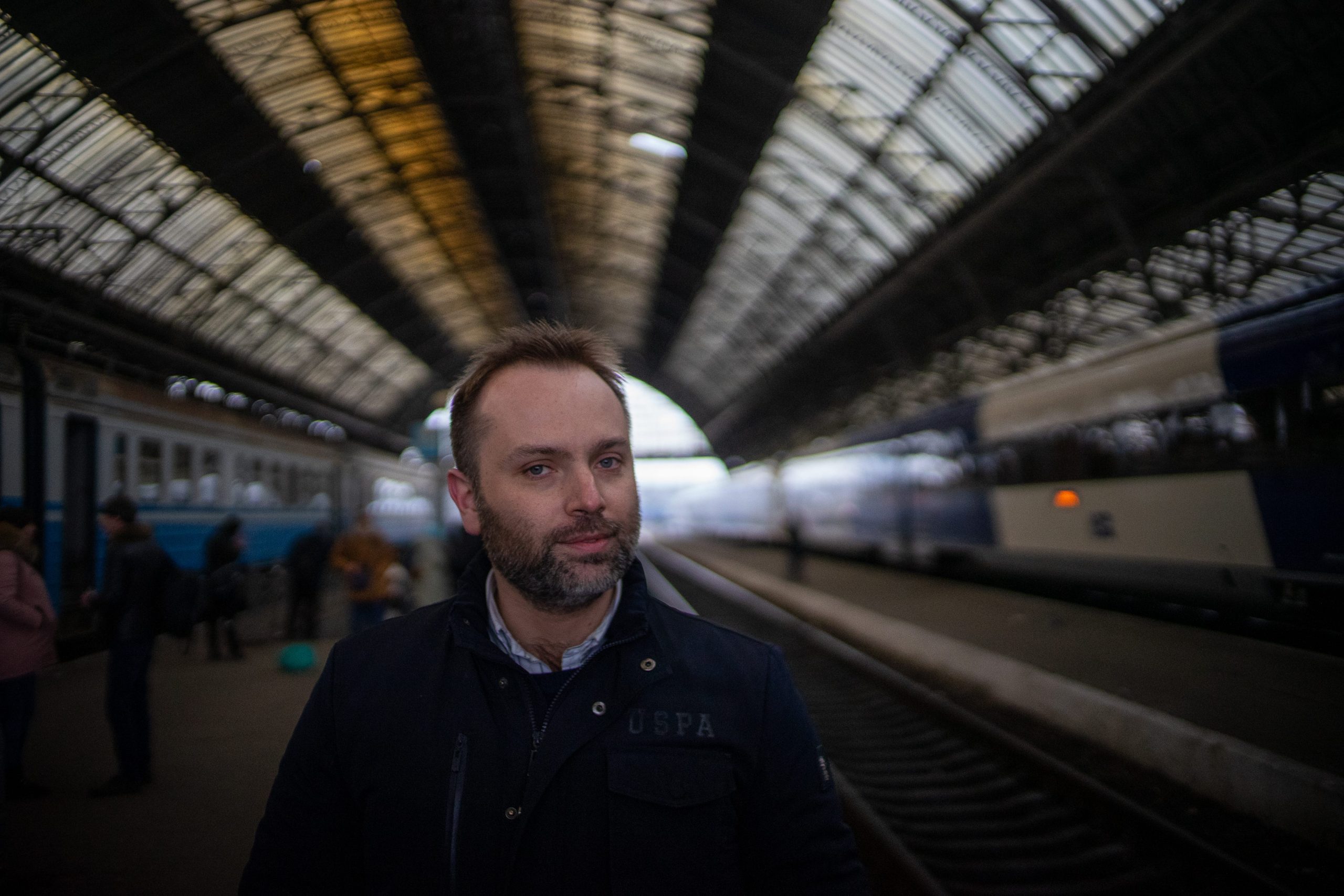 A man is seen on a train platform.